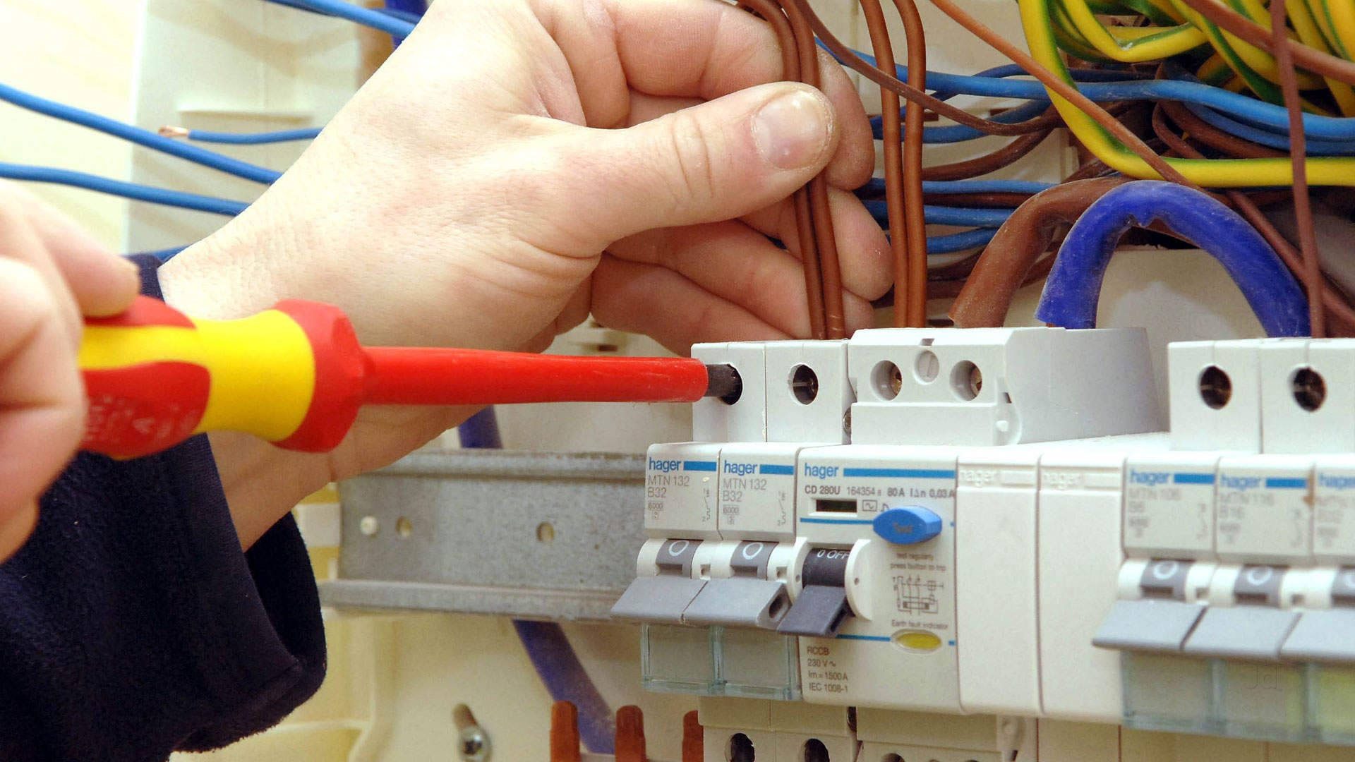 red and yellow screwdriver, white electrical circuit breaker panel, hands, Full HD Desktop Wallpaper