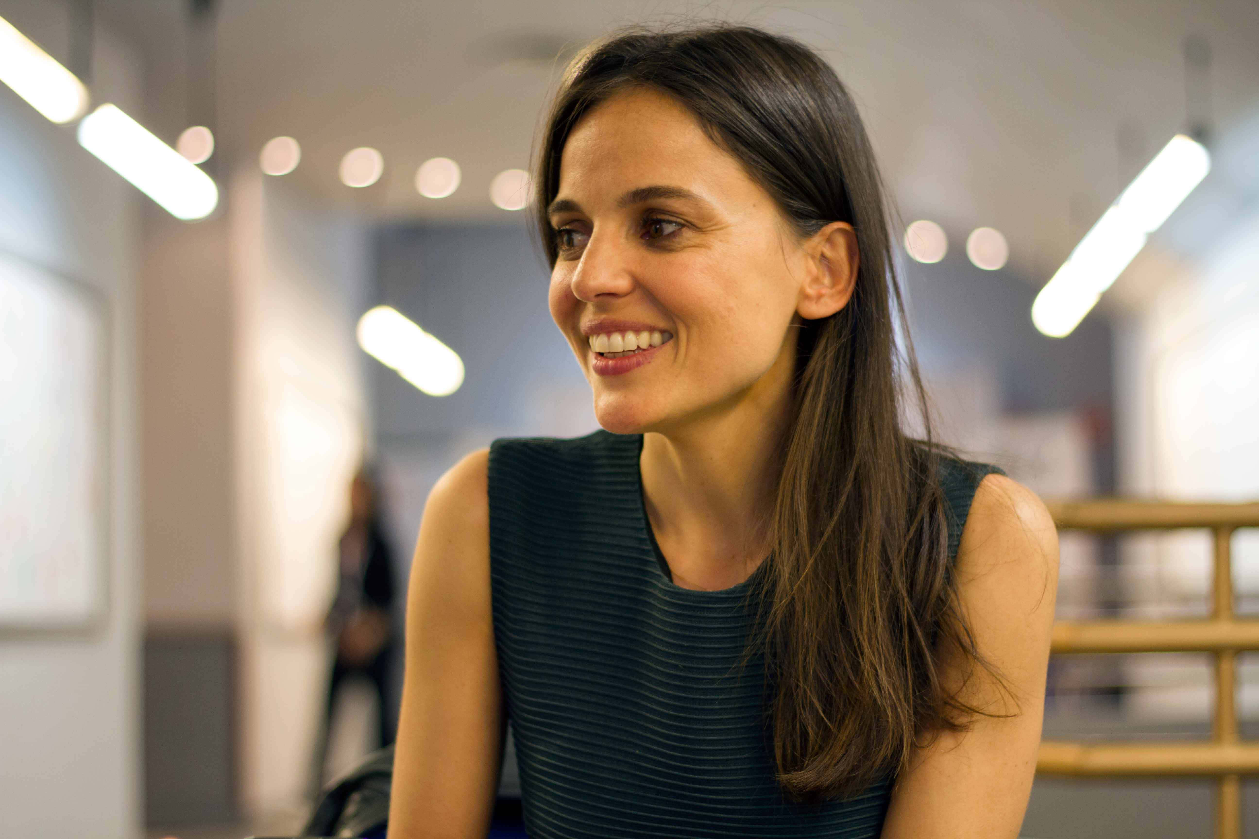 Elena Anaya, long dark hair, softly lit modern office space, 5K Desktop Wallpaper