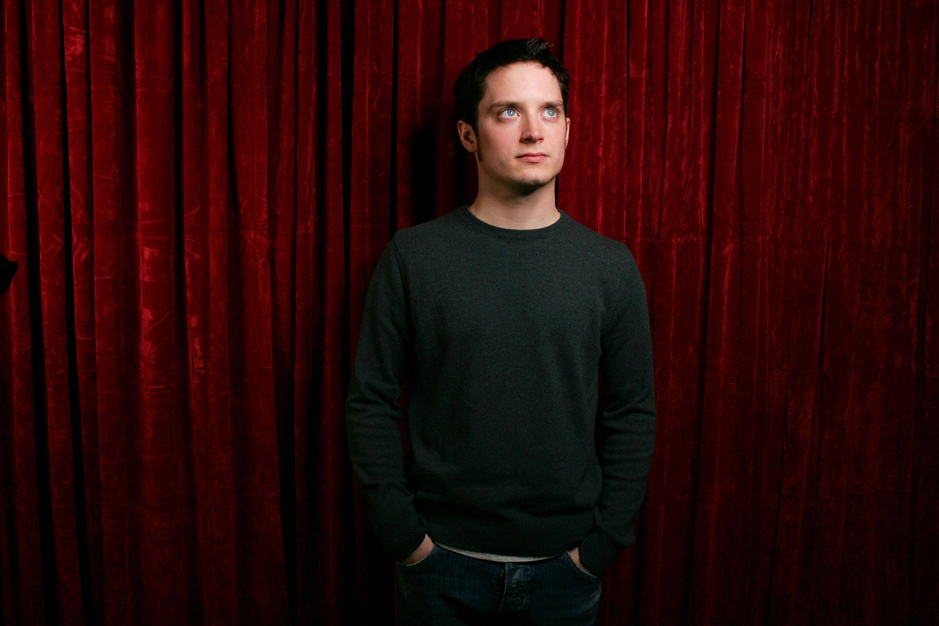Elijah Wood, red velvet curtain, dark sweater, 2K Desktop Wallpaper