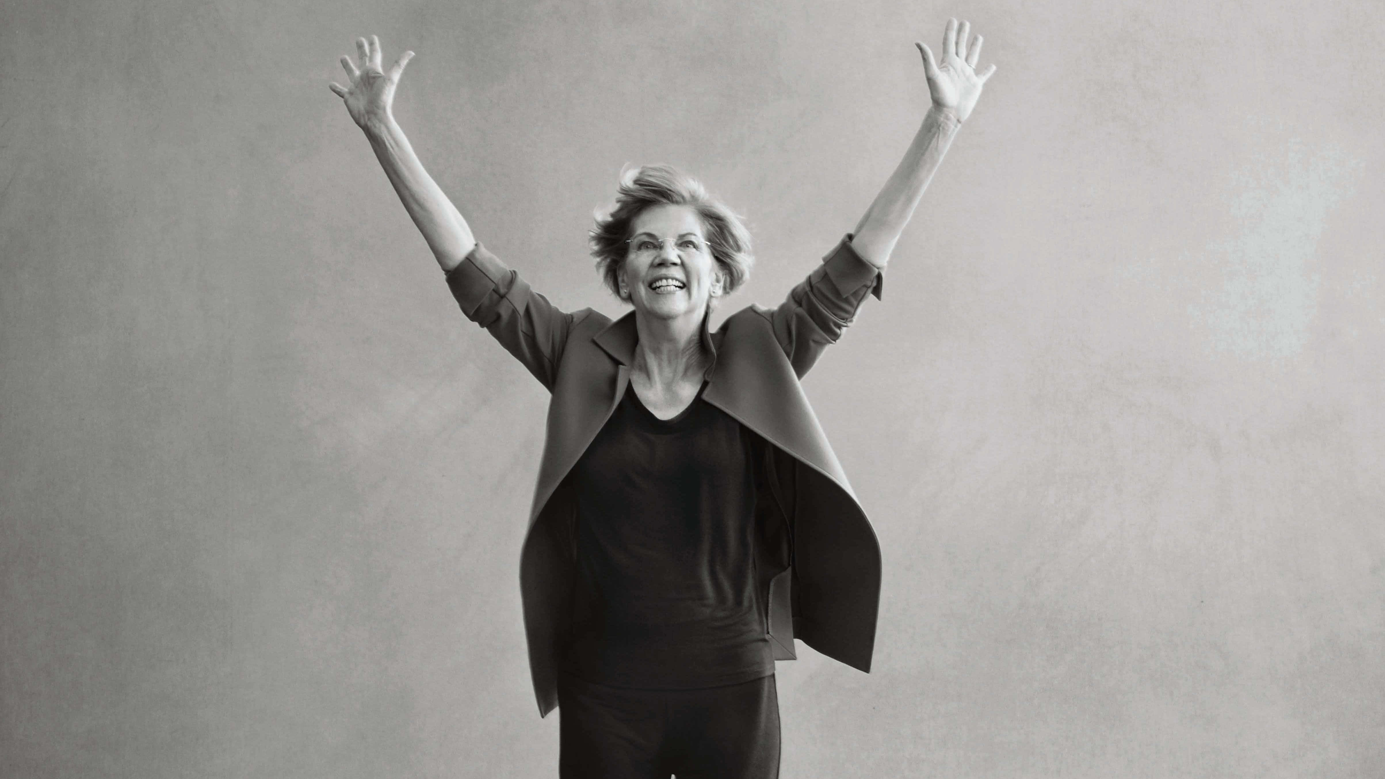 Elizabeth Warren, raised arms, textured gray studio backdrop, 4K Desktop Wallpaper