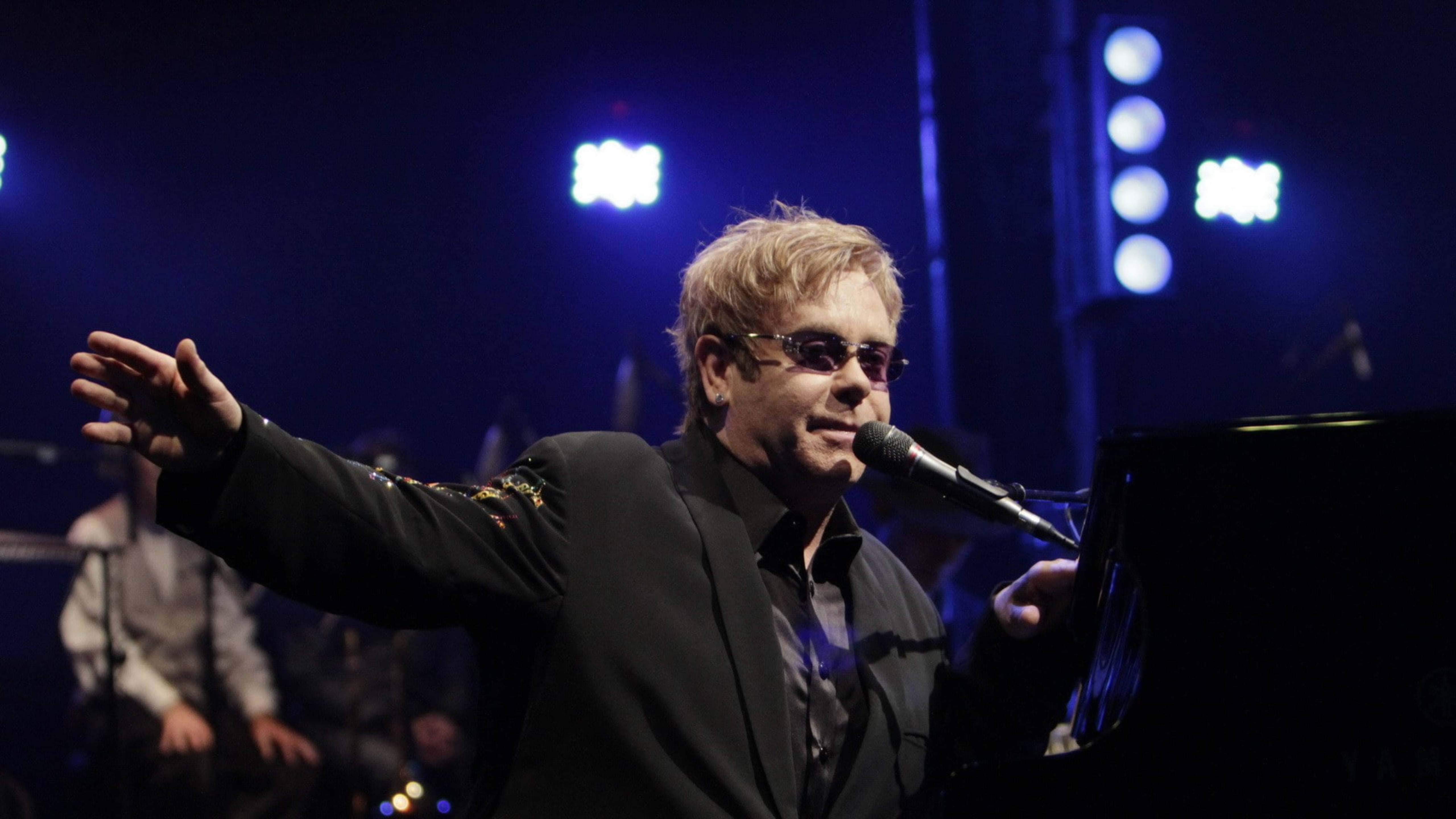 Elton John, black suit, blue stage lights, 5K Desktop Wallpaper