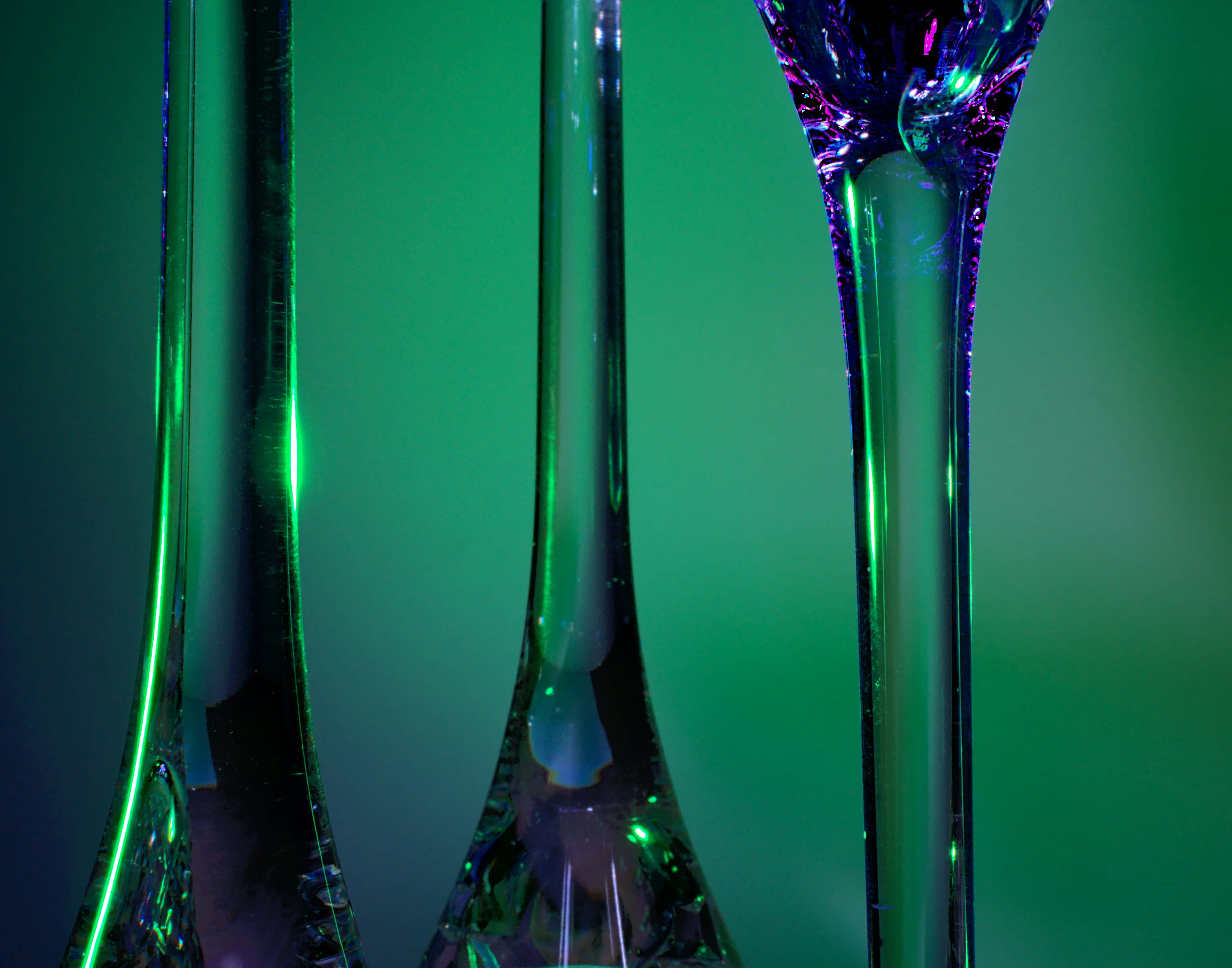 emerald glass artistry, champagne flutes, iridescent purple and green highlights, 4K Desktop Wallpaper