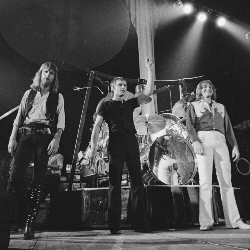 Emerson Lake And Palmer, 1970s rock attire, dimly lit stage, SD Desktop Wallpaper