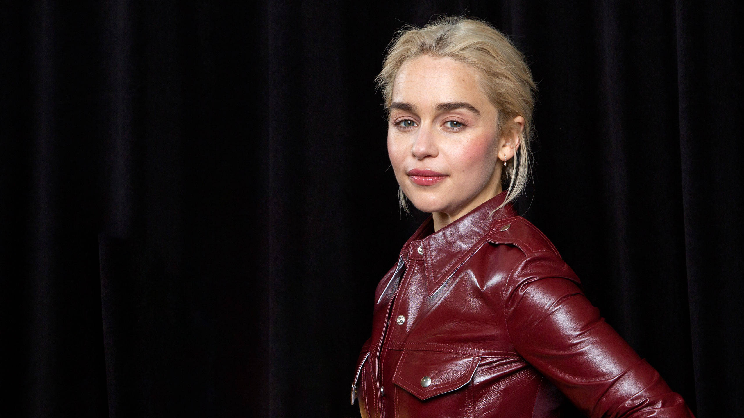 Emilia Clarke, glossy red leather jacket, dark velvet curtain, 2K Desktop Wallpaper