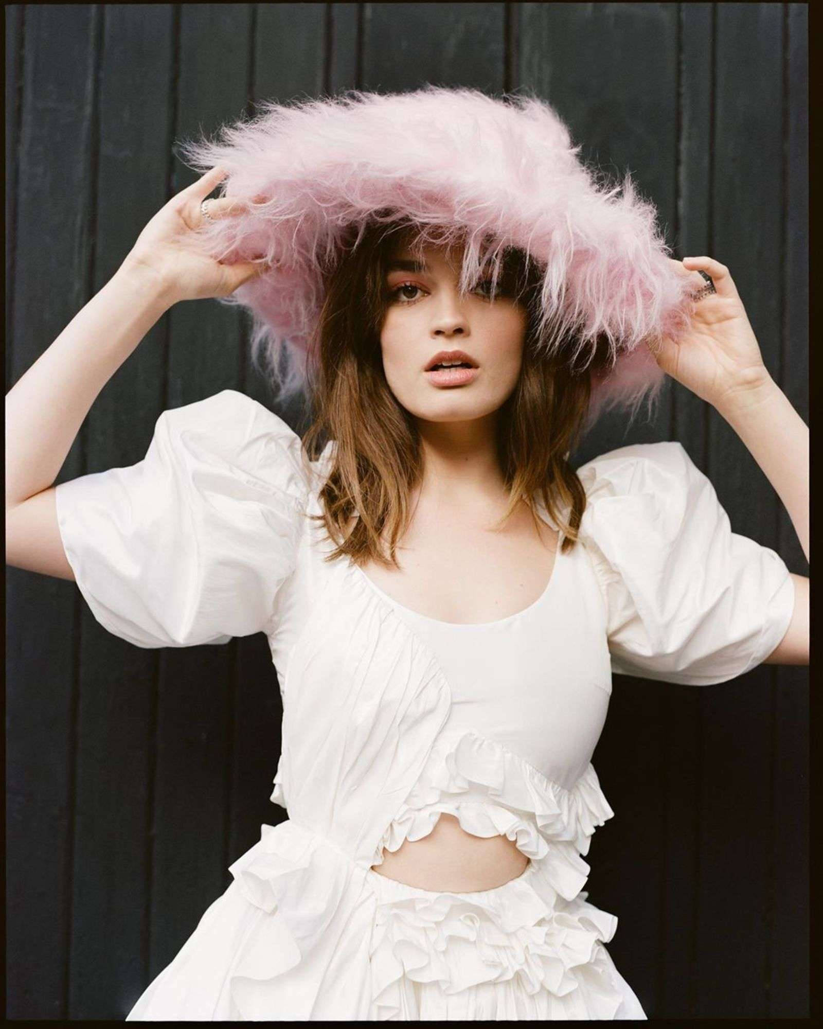Emma Mackey, pink feathered hat, white ruffled dress, Full HD Phone Wallpaper