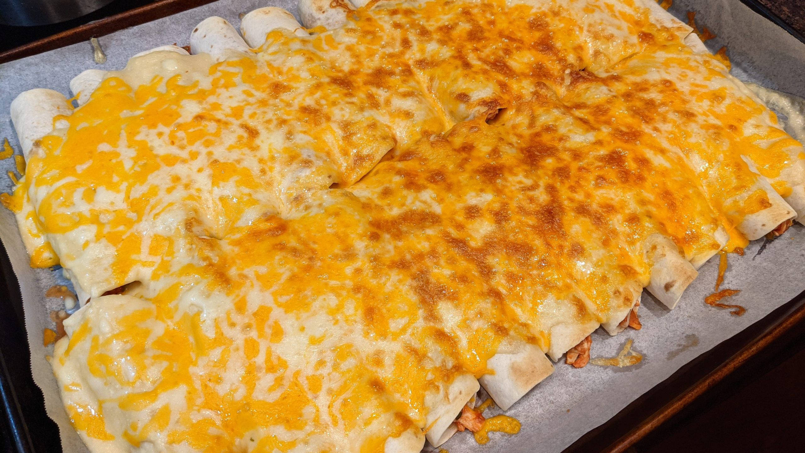 cheesy enchiladas, golden melted cheese, freshly baked rolled enchiladas, 2K Desktop Wallpaper