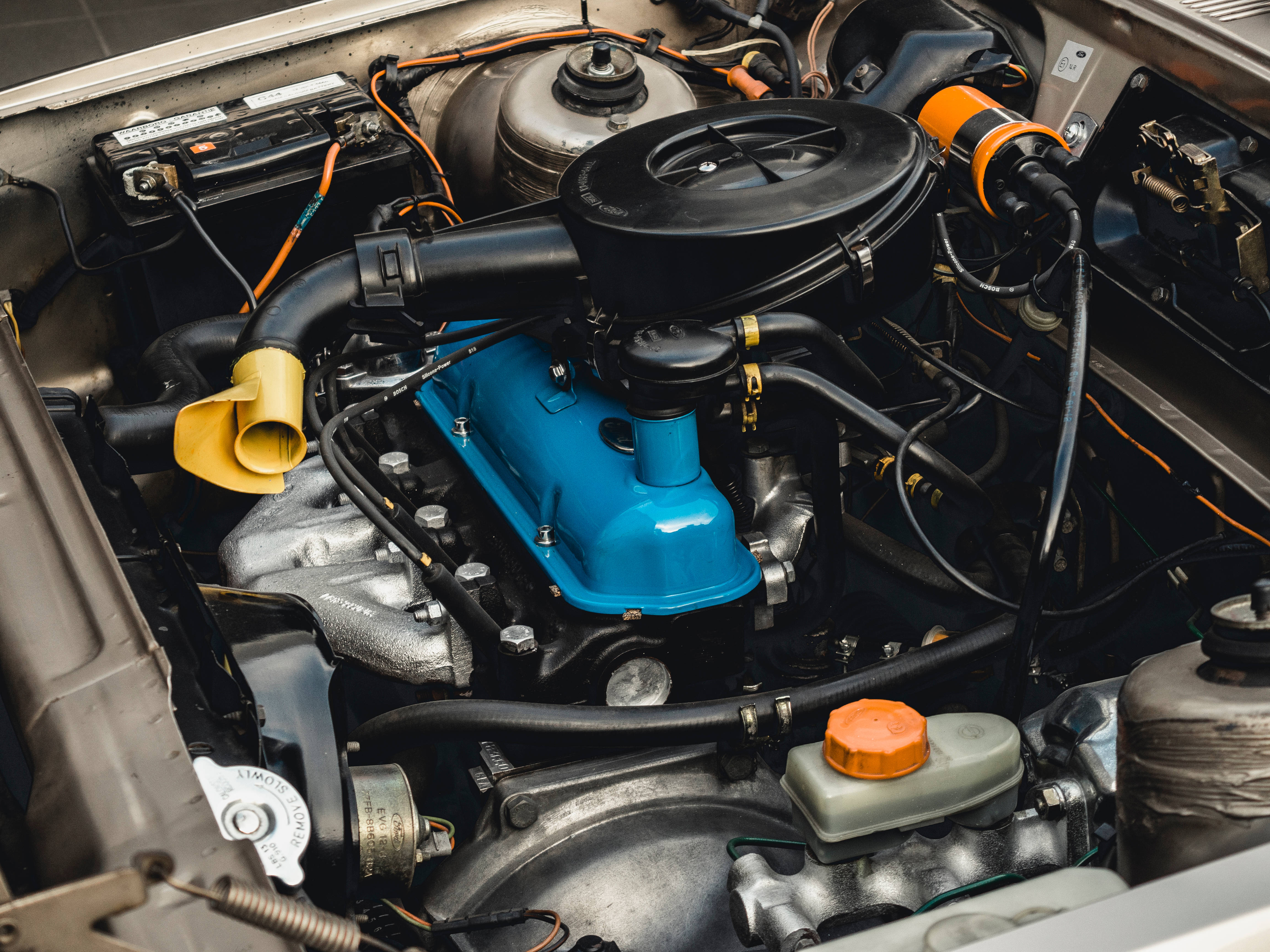 vintage car engine, vibrant blue valve cover, orange accents, 4K Desktop Wallpaper