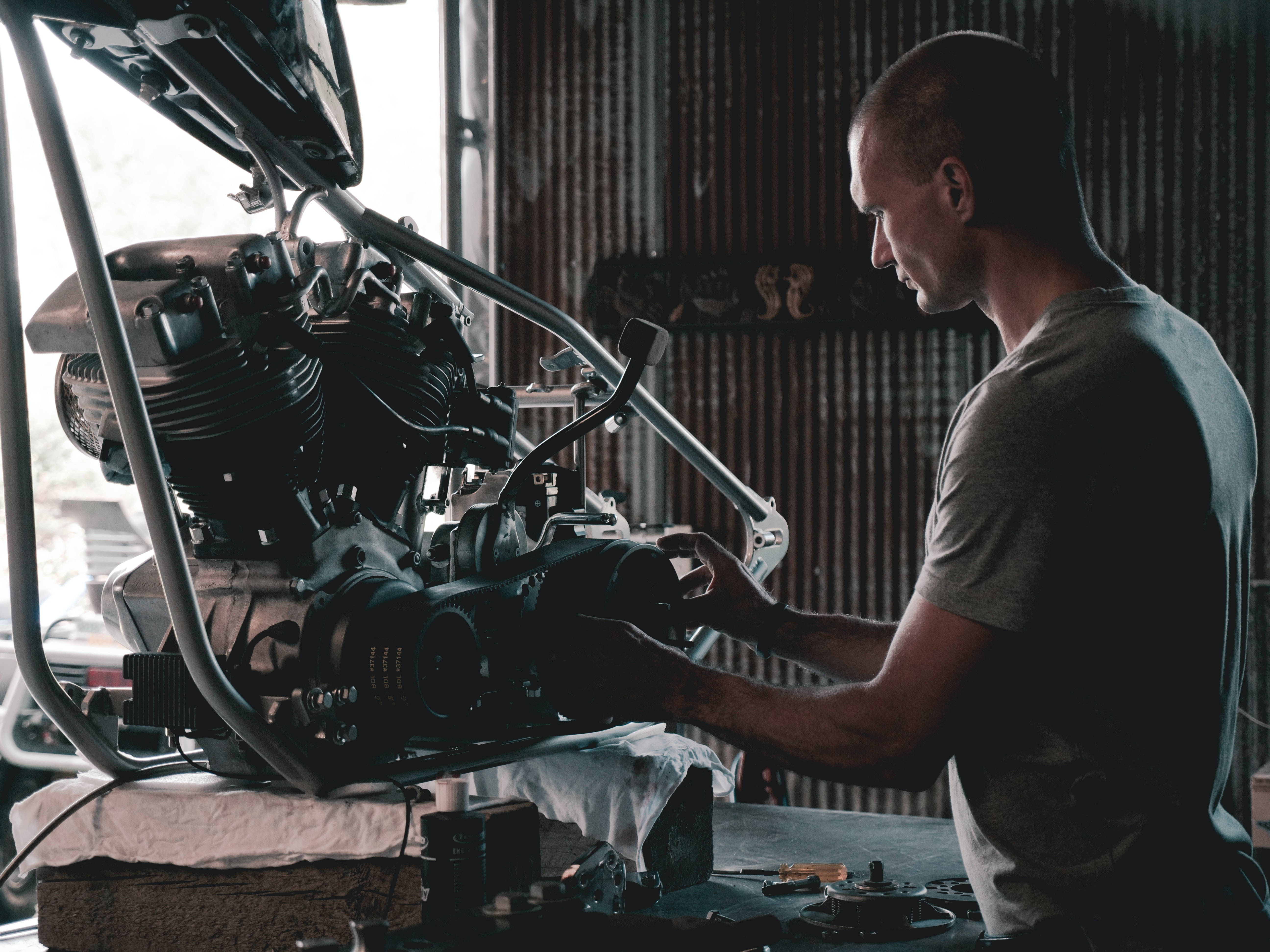 mechanic, motorcycle engine, dimly lit garage, 5K Desktop Wallpaper