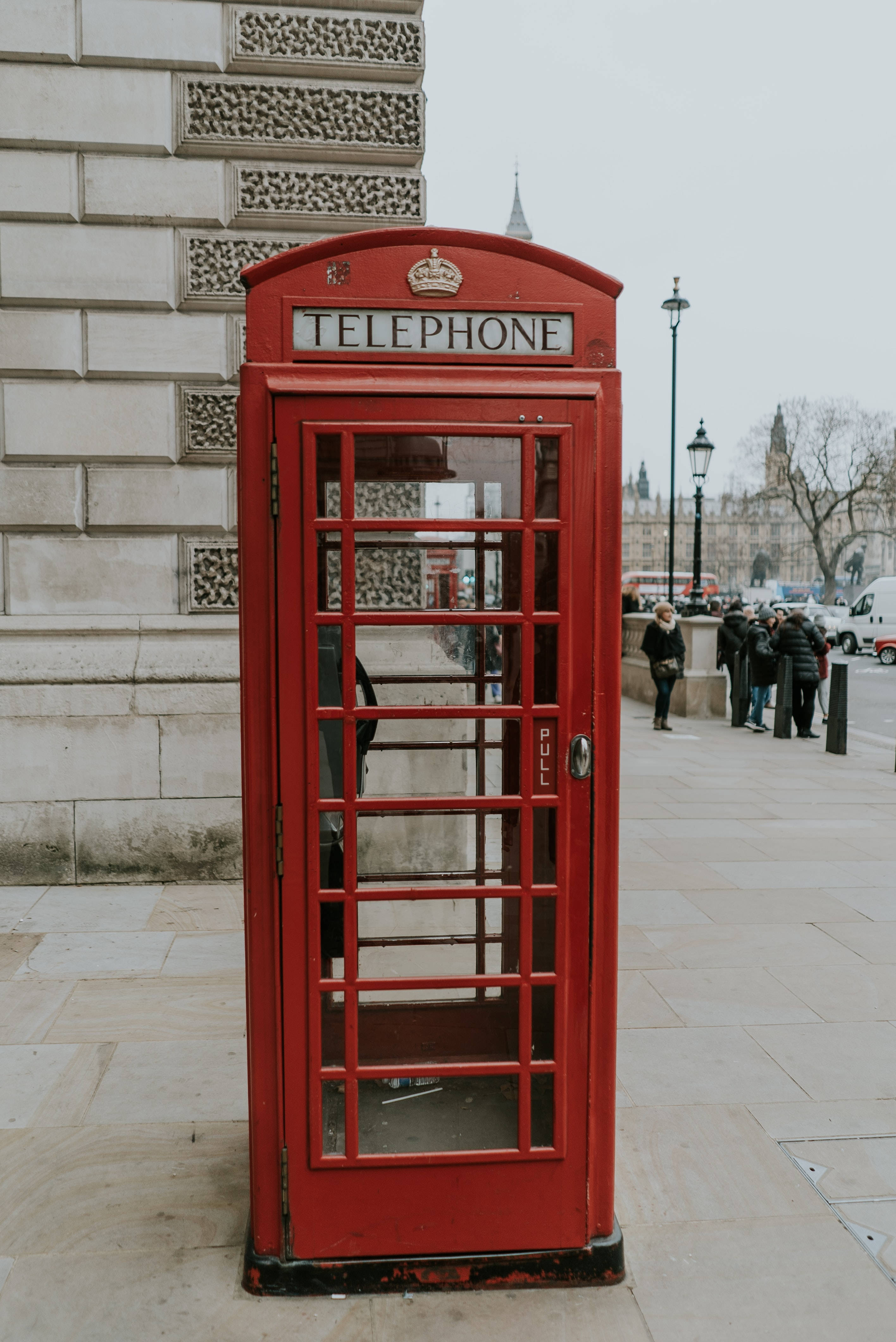 red British telephone box, stone sidewalk, historic building, 4K Phone Wallpaper