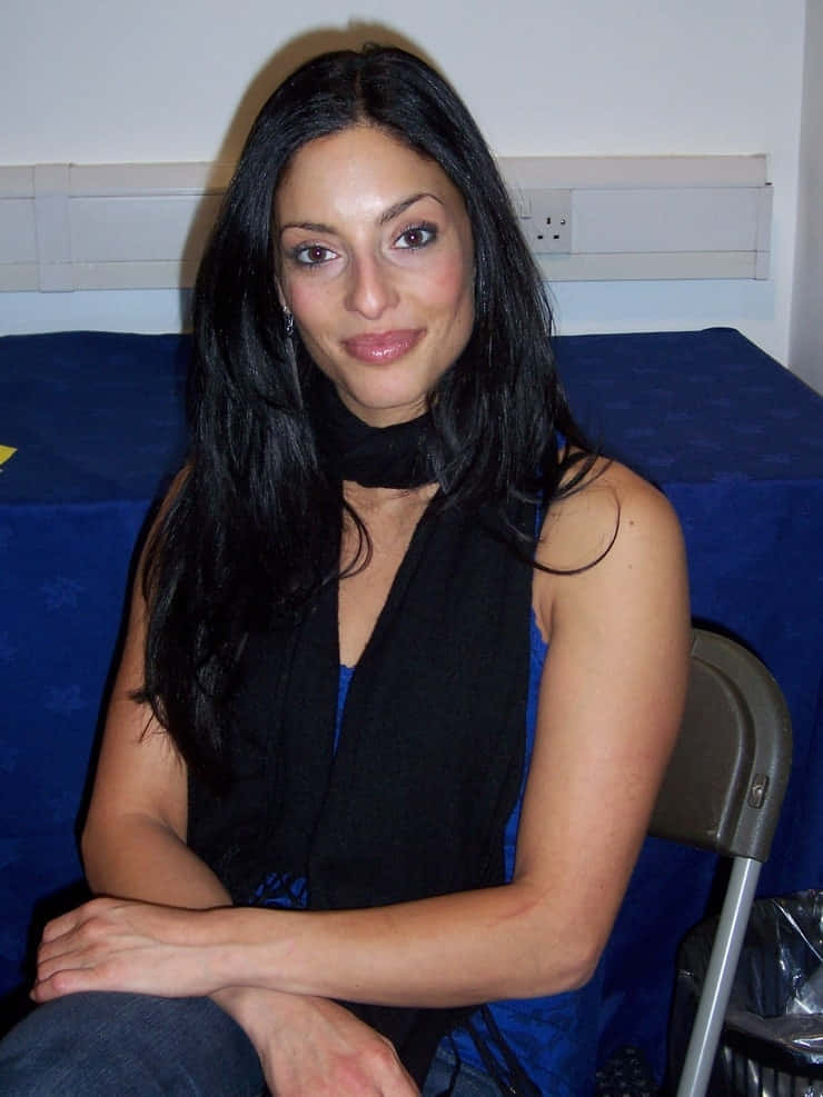 Erica Cerra, black top, blue backdrop, SD Phone Wallpaper