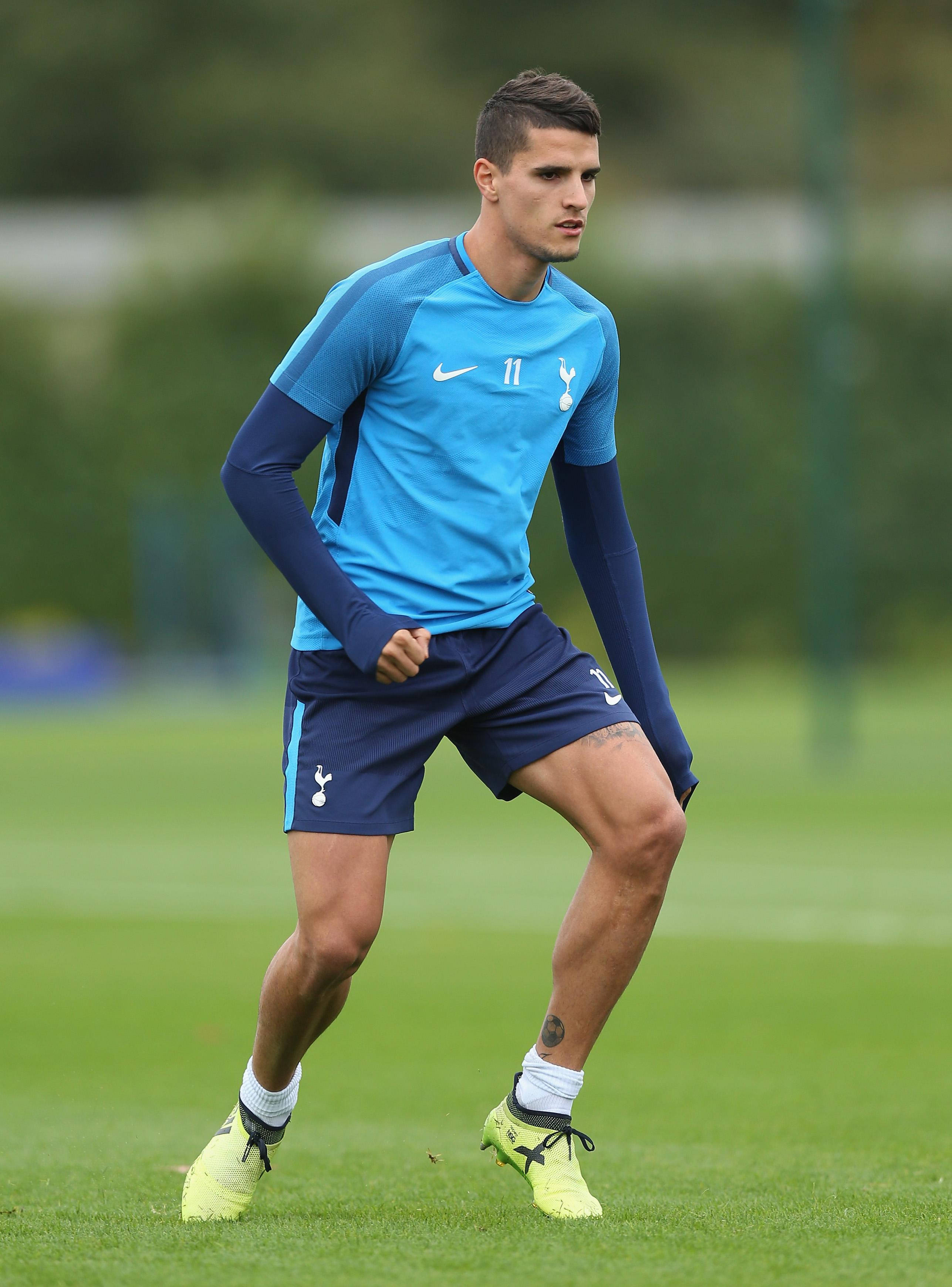 Erik Lamela, lush green football field, blue training gear, 2K Phone Wallpaper