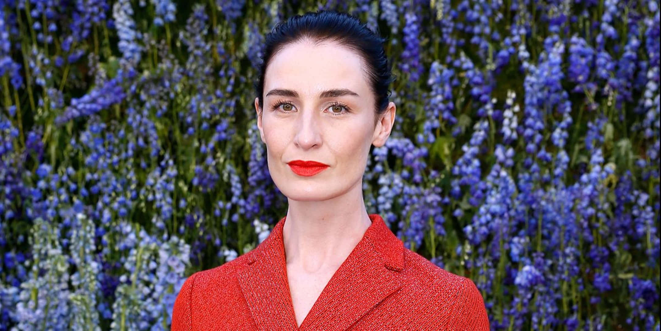 Erin O'Connor, red textured blazer, vibrant blue flower wall, Full HD Desktop Wallpaper