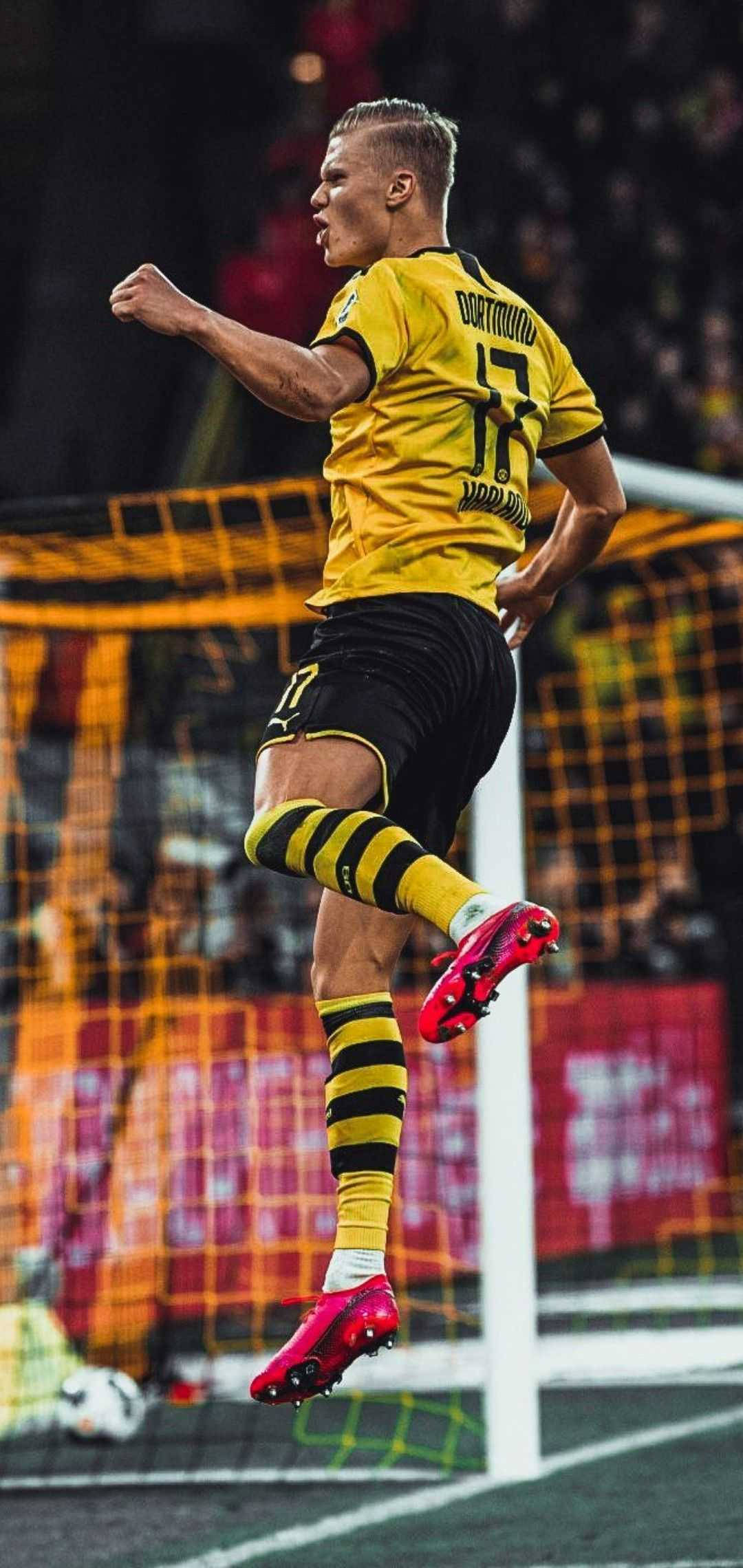 Erling Haaland, yellow and black uniform, leaps midair, Full HD Phone Wallpaper