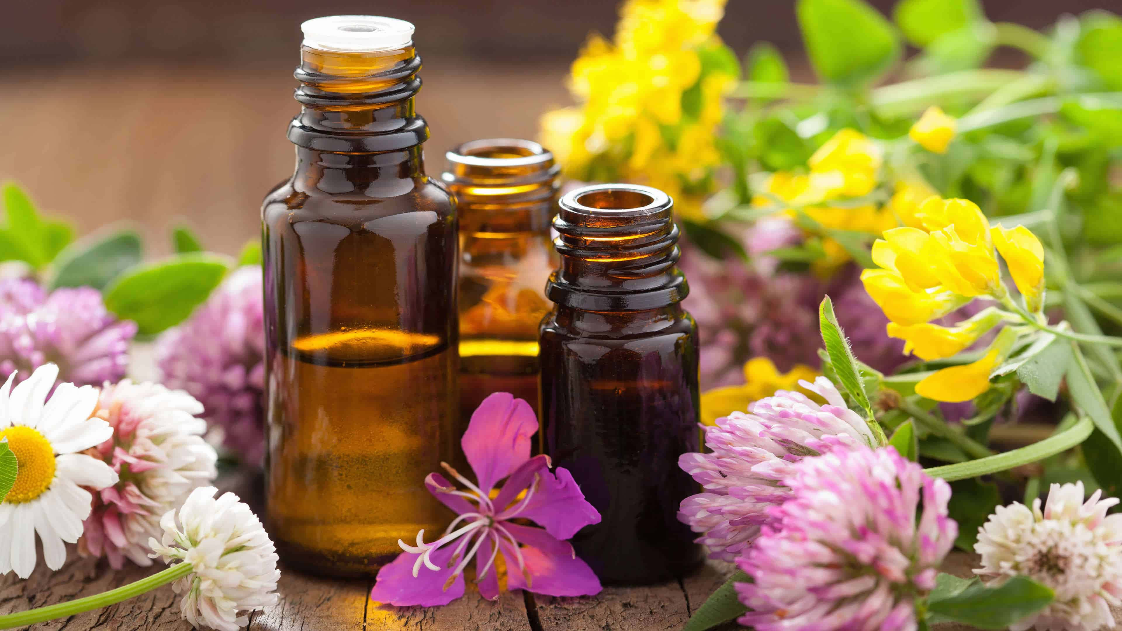 amber glass bottles, essential oil, vibrant yellow pink and white wildflowers, 4K Desktop Wallpaper