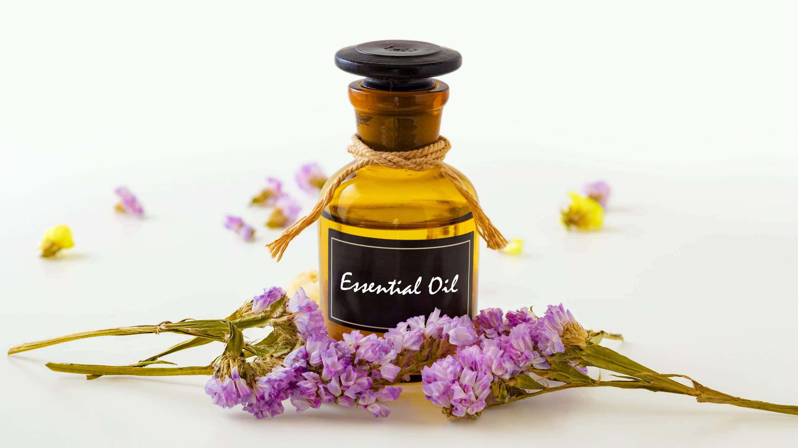 amber glass bottle, essential oil, dried purple and yellow flowers, 2K Desktop Wallpaper