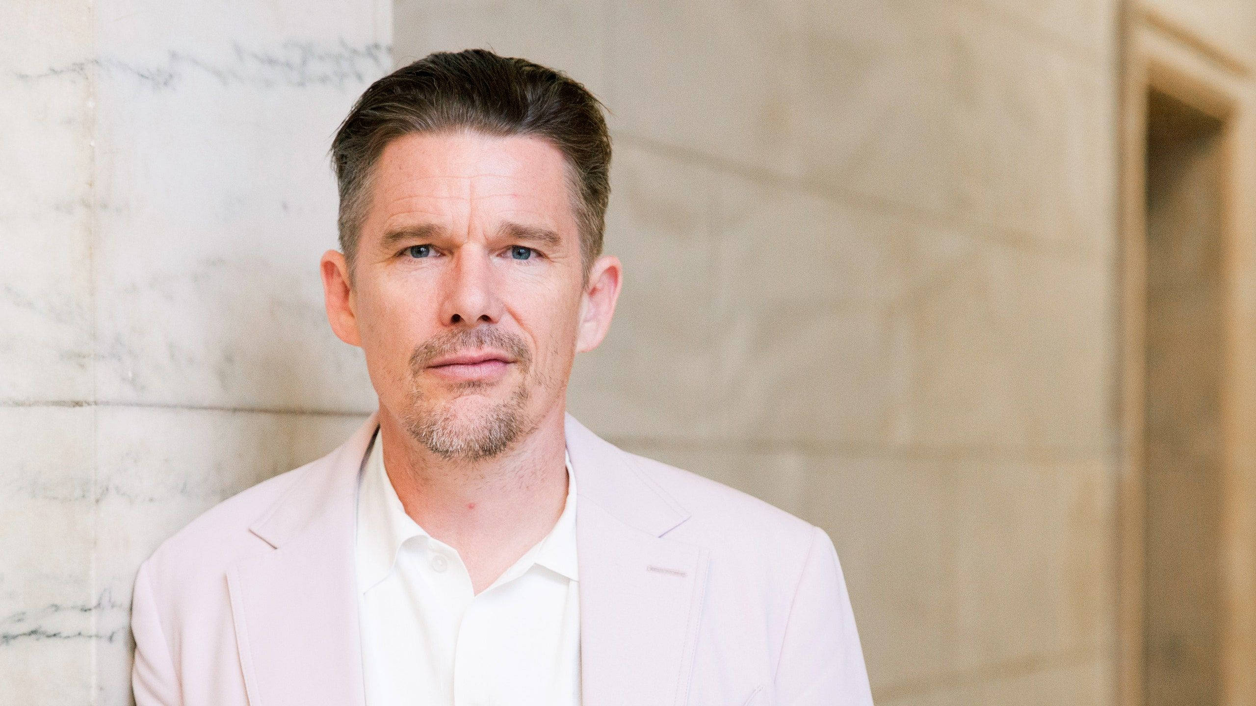 Ethan Hawke, pale pink blazer, marble wall, 2K Desktop Wallpaper