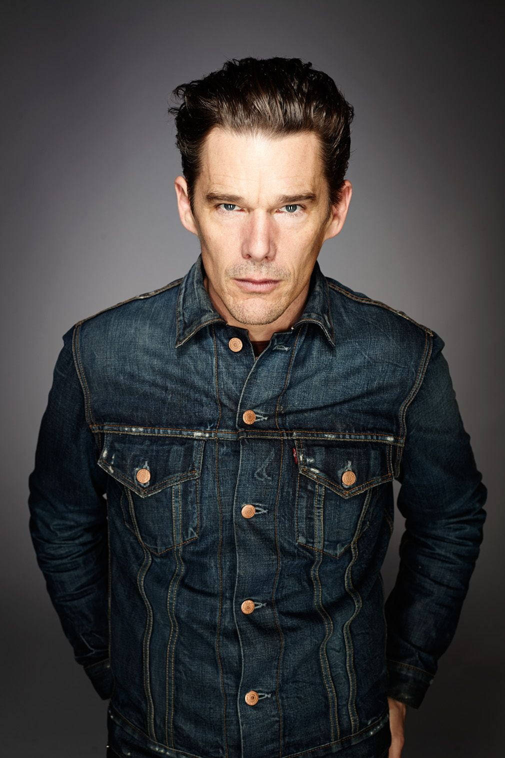 Ethan Hawke, dark denim jacket, muted gray studio background, HD Phone Wallpaper