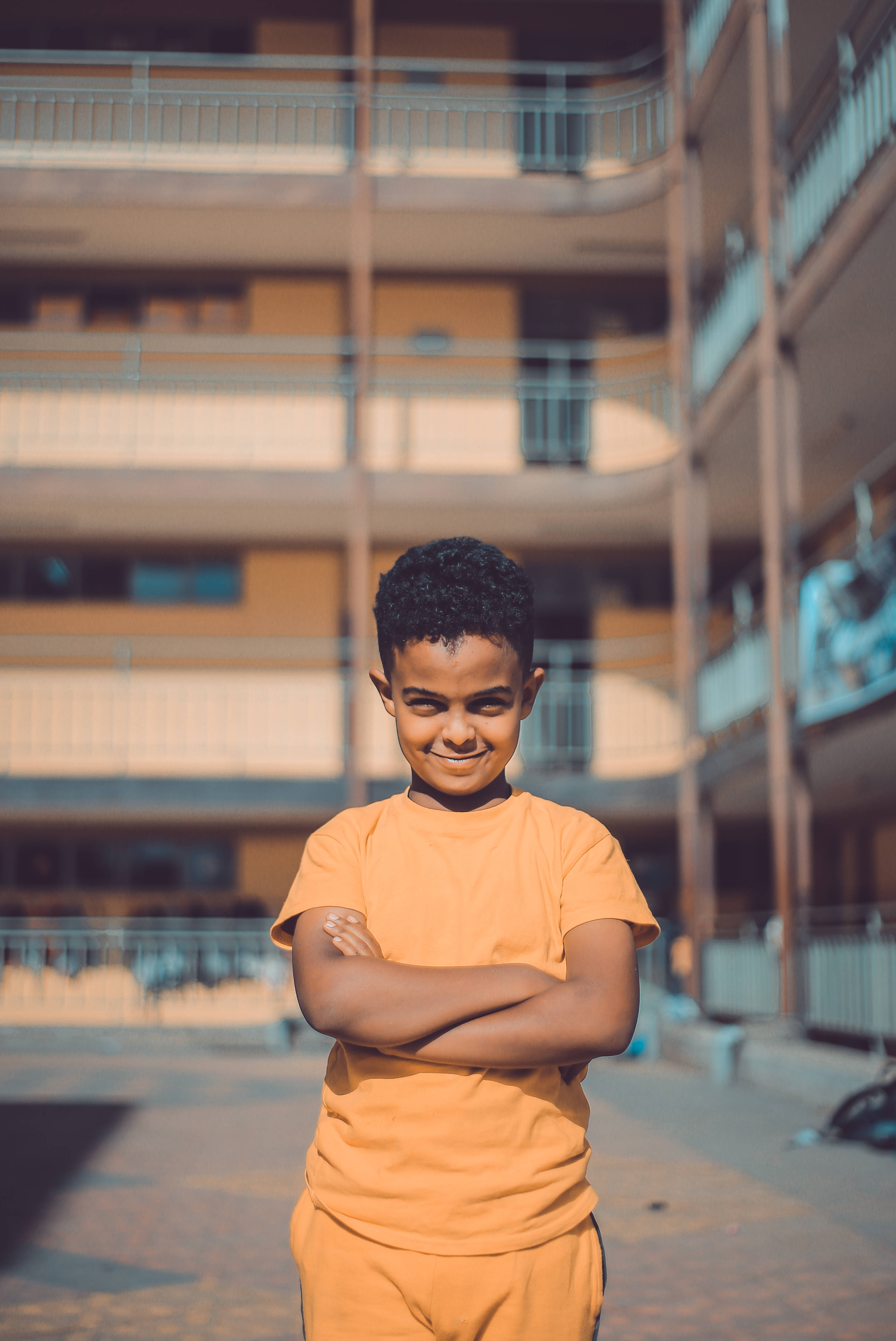 Ethiopia Boy, orange building, sunlit courtyard, 5K Phone Wallpaper