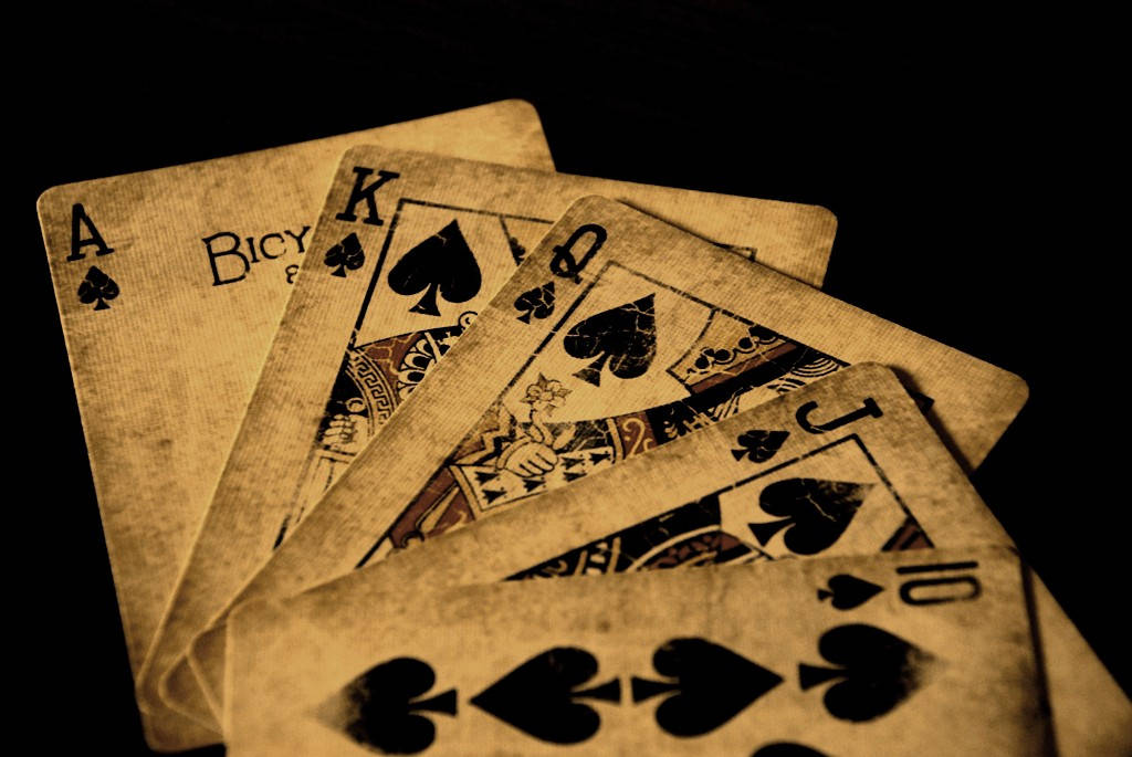 vintage spade playing cards, deep black background, glowing warmly, SD Desktop Wallpaper