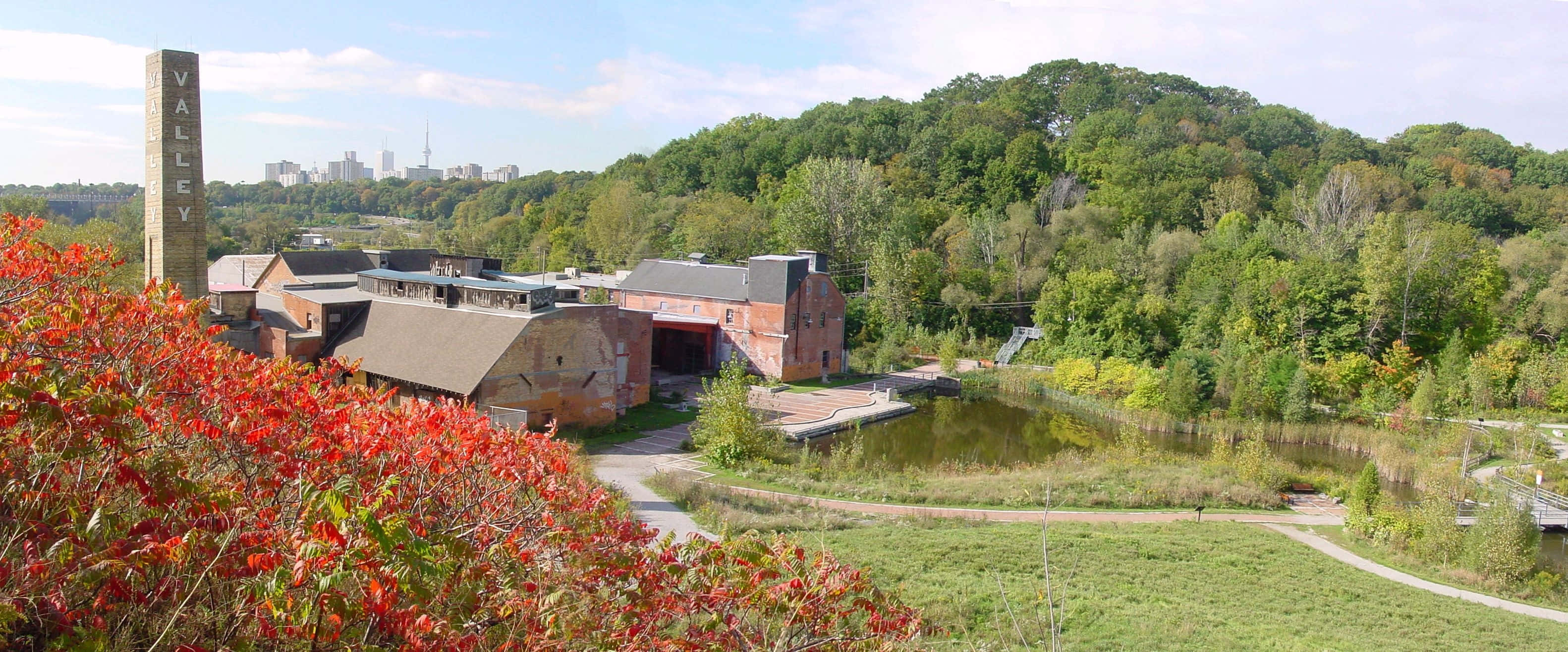 Evergreen Brick Works, autumn scenery, vibrant red foliage, 2K Desktop Wallpaper