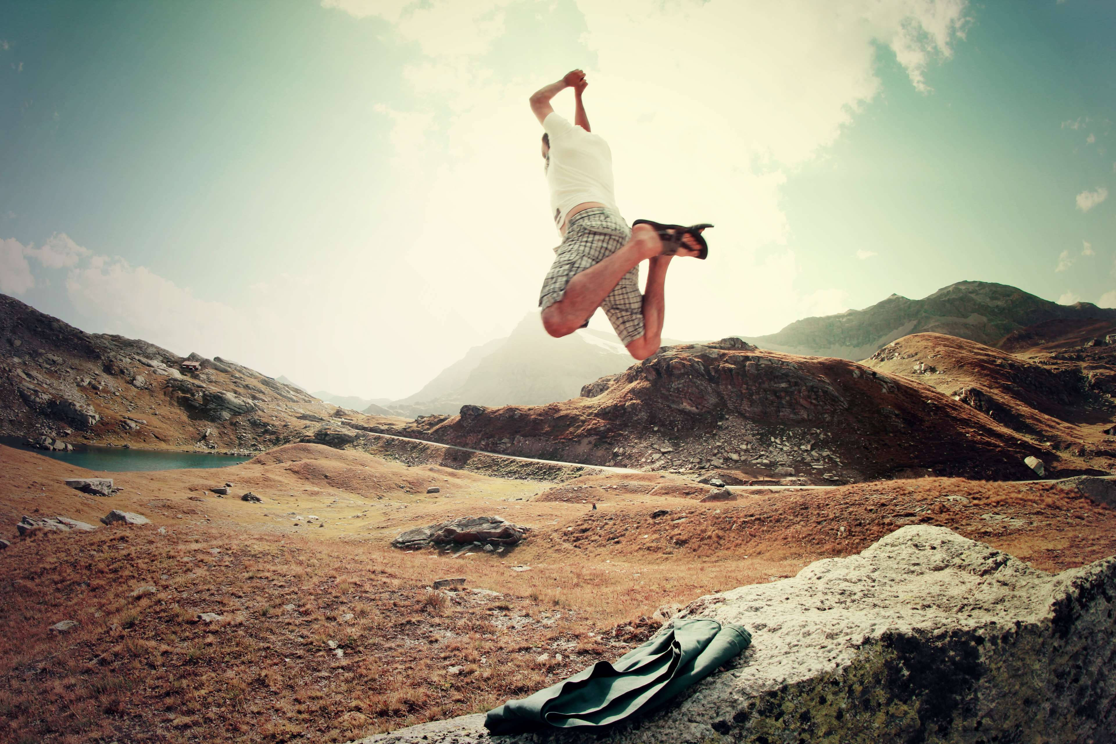 Excited Jumping Guy, rocky mountain landscape, lake, 4K Desktop Wallpaper