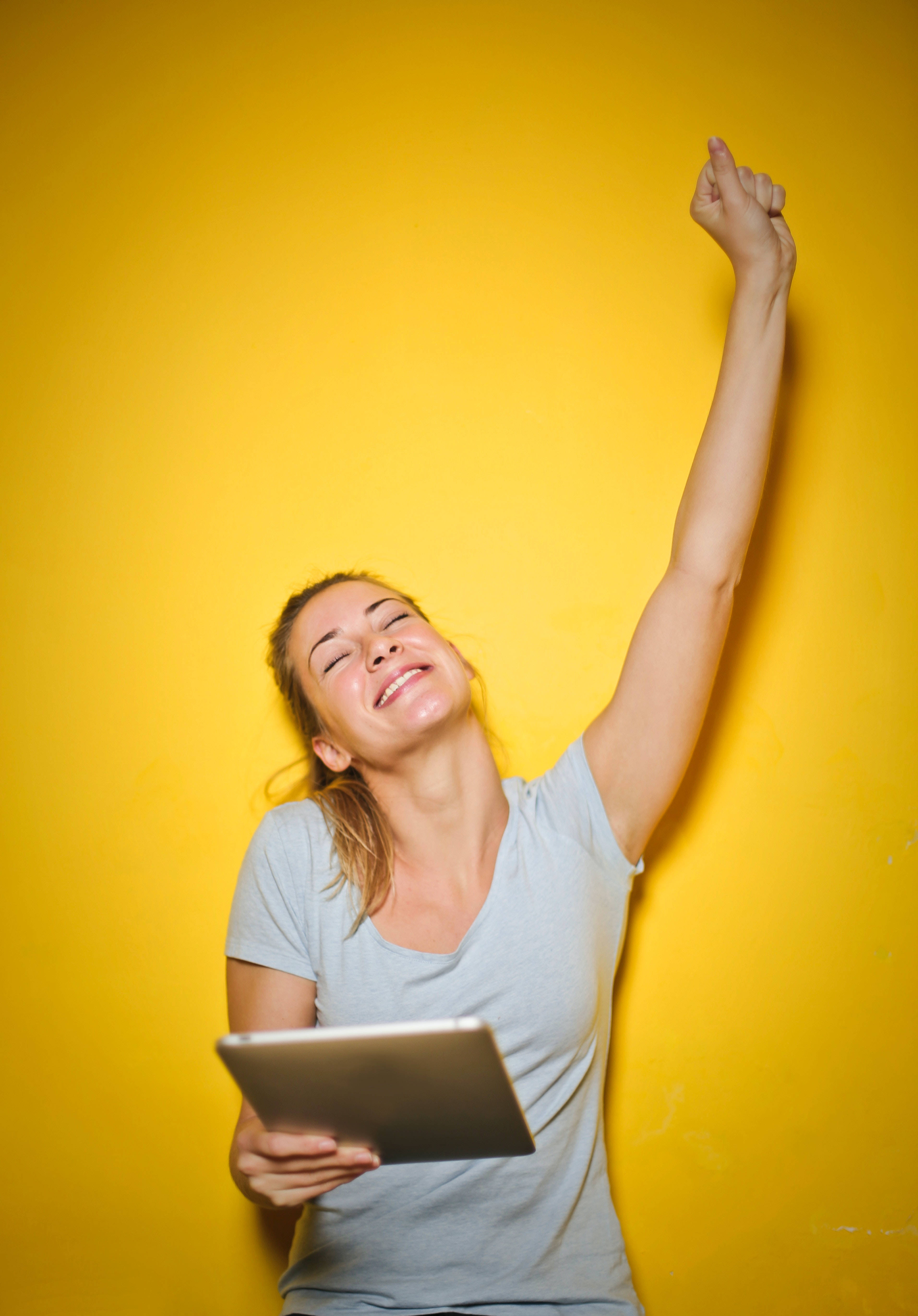 excited woman, yellow aesthetic, gray tshirt, 5K Phone Wallpaper