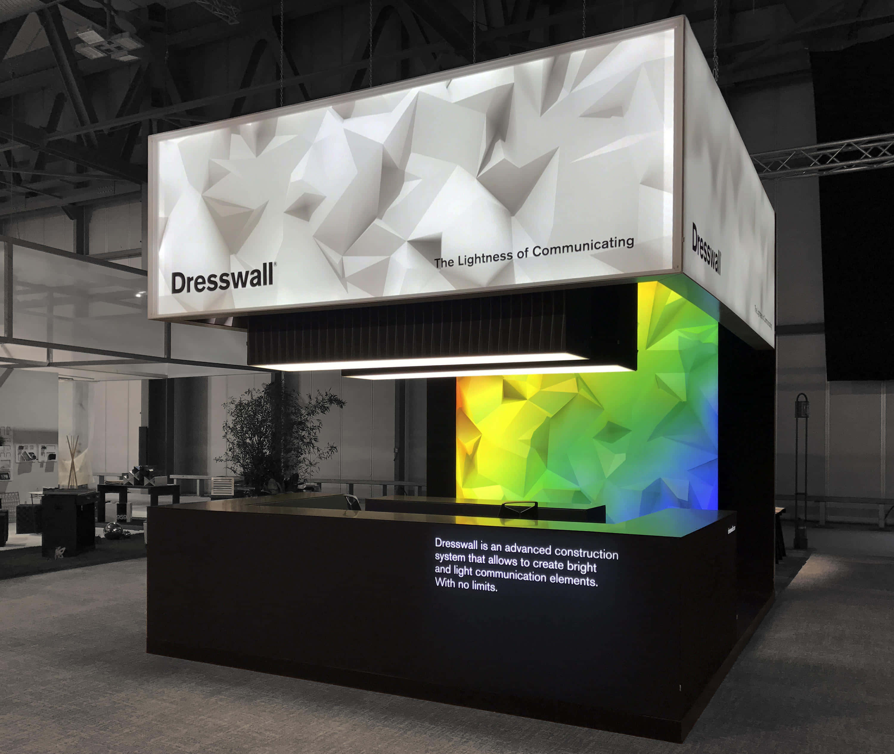 exhibition, white geometric overhead sign, vibrant rainbow-lit geometric wall display, 2K Desktop Wallpaper