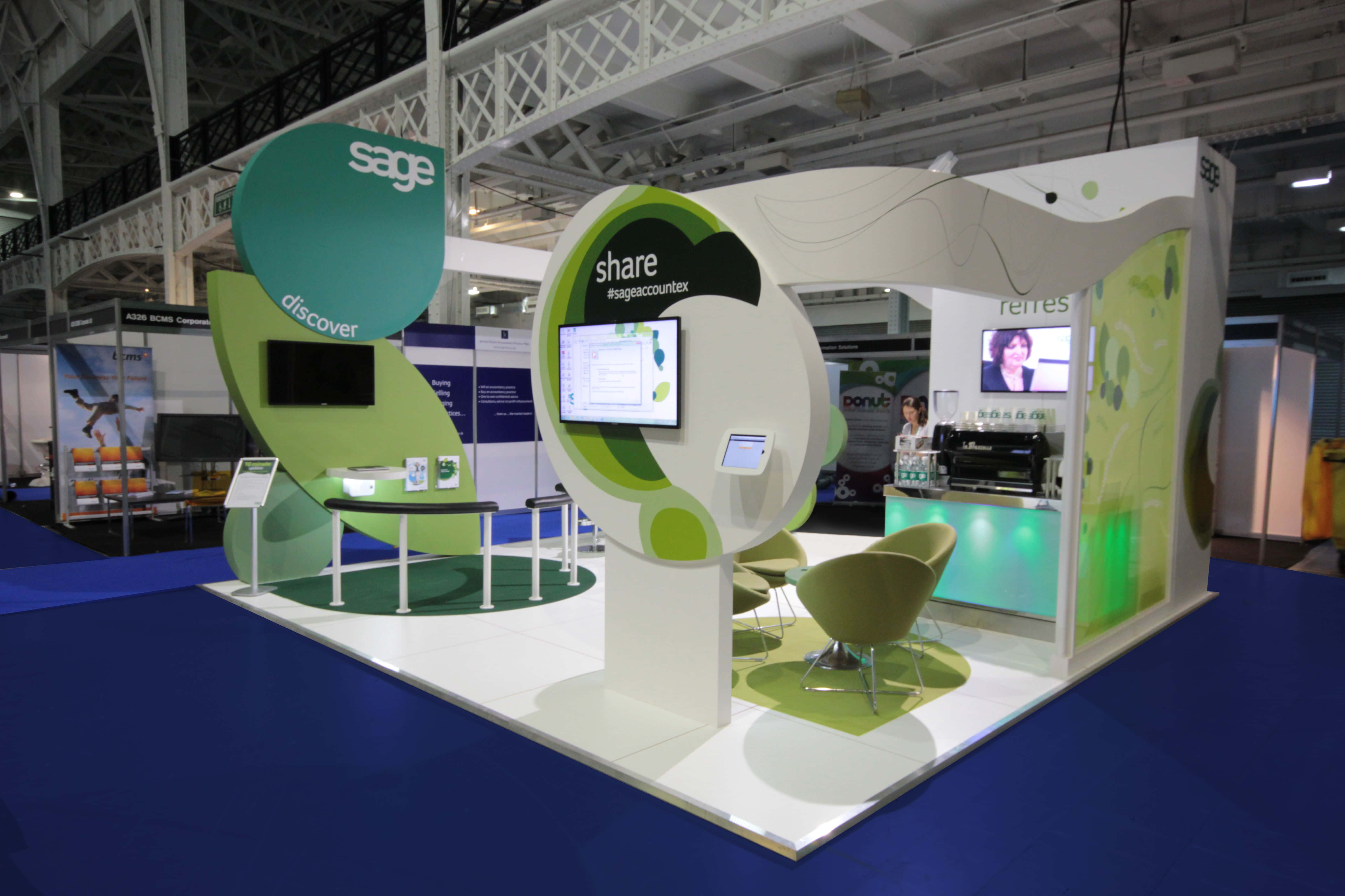 Sage corporate booth, green and white curved structures, trade show, 5K Desktop Wallpaper