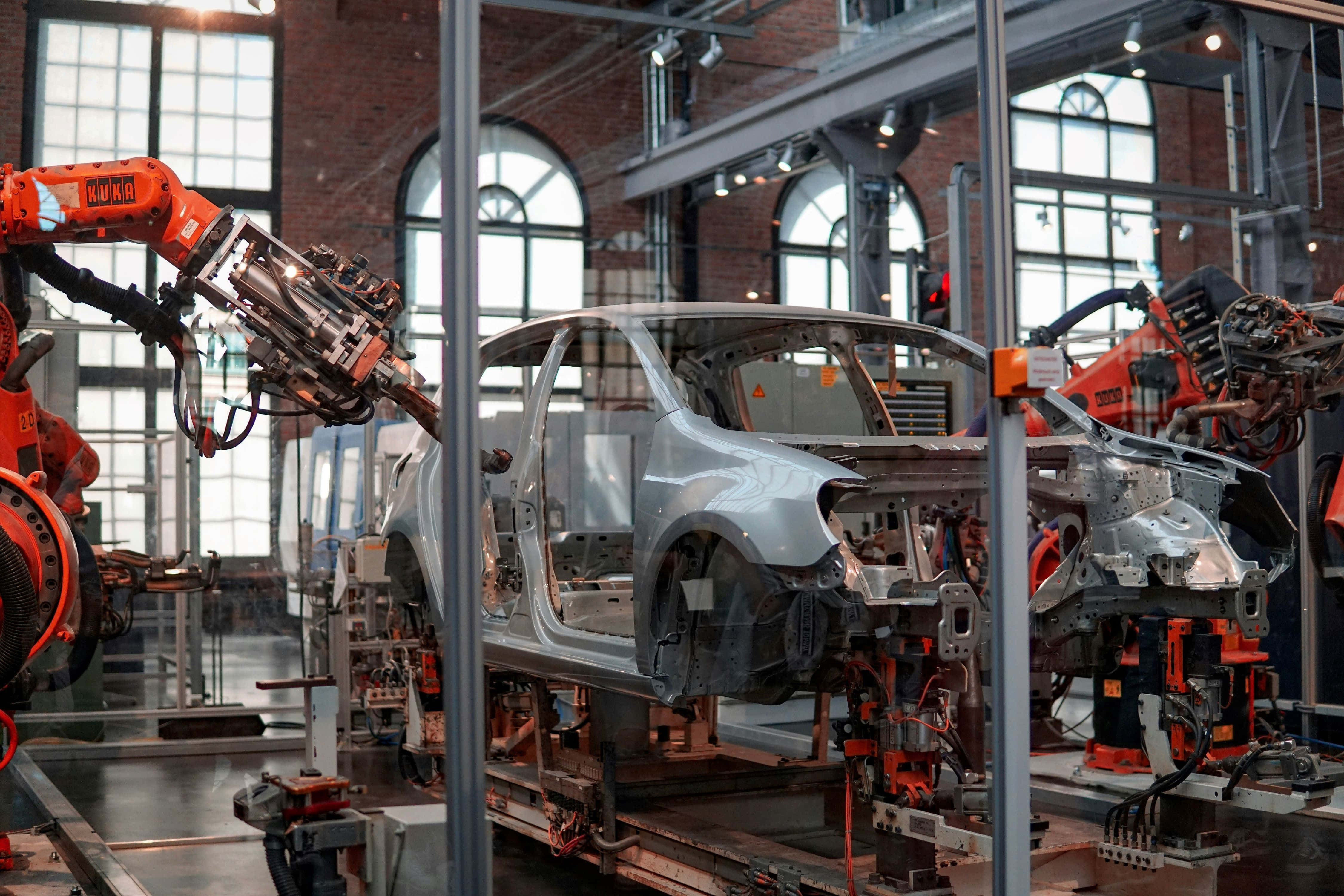 automotive robotics assembly line, silver car frame, bright industrial factory, 4K Desktop Wallpaper
