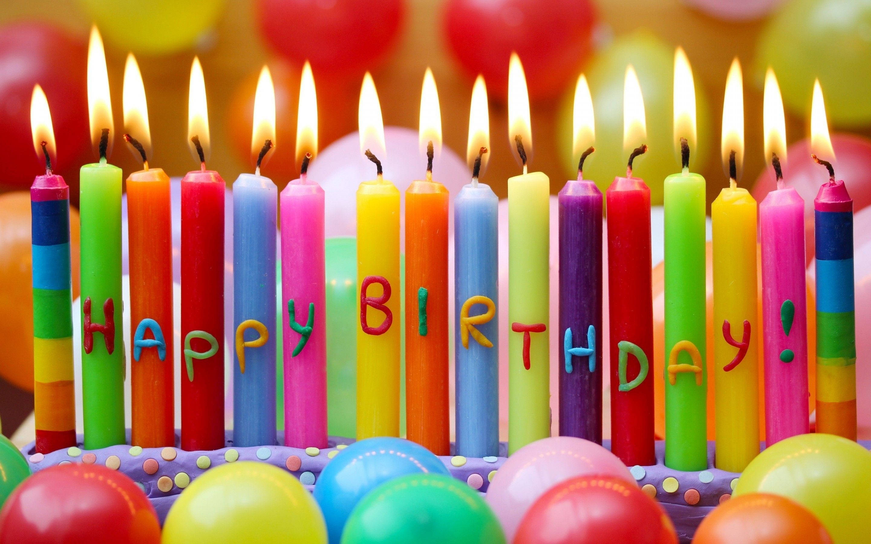 rainbow birthday candles, flickering flames, colorful cake, 2K Desktop Wallpaper
