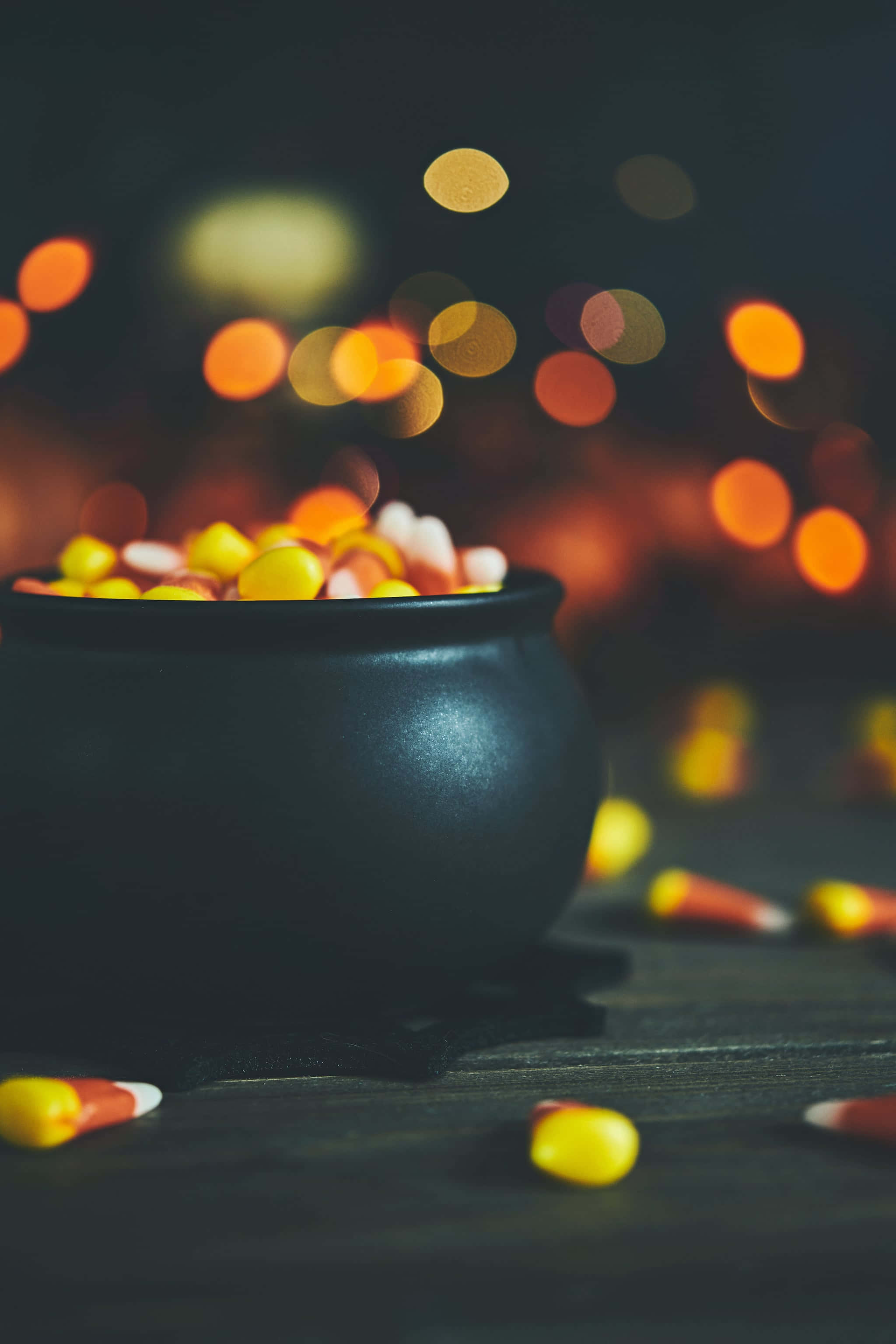 black cauldron, candy corn, dark wooden table, 2K Phone Wallpaper