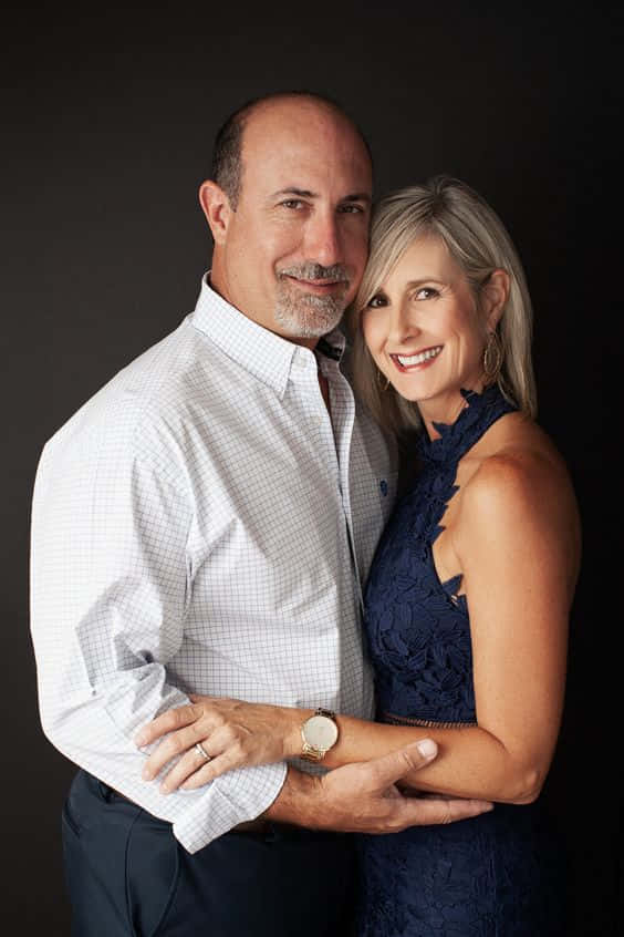 Family Portrait, middle-aged couple, dark studio backdrop, SD Phone Wallpaper