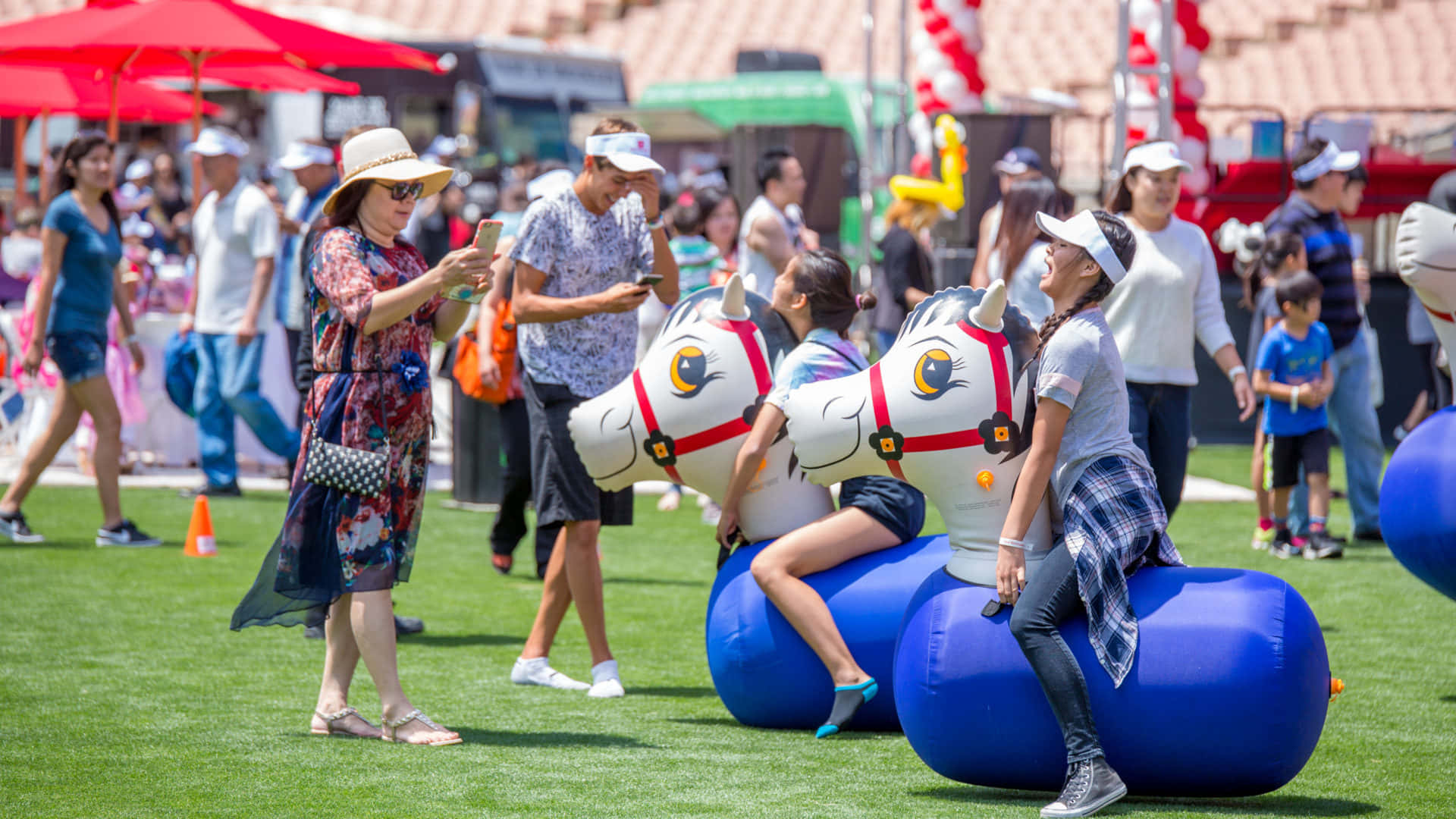 Family Day, giant blue inflatable horses, sunny outdoor festival, Full HD Desktop Wallpaper
