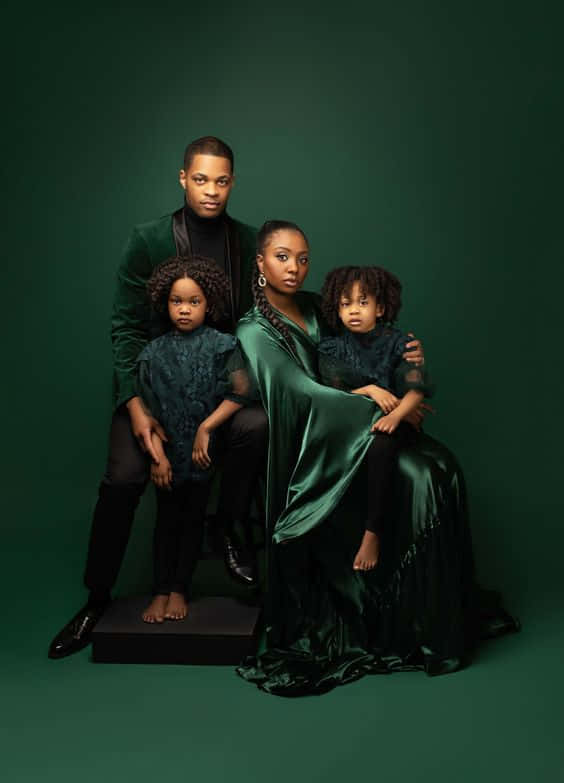 family of four, emerald green velvet and satin attire, dark green studio backdrop, SD Phone Wallpaper