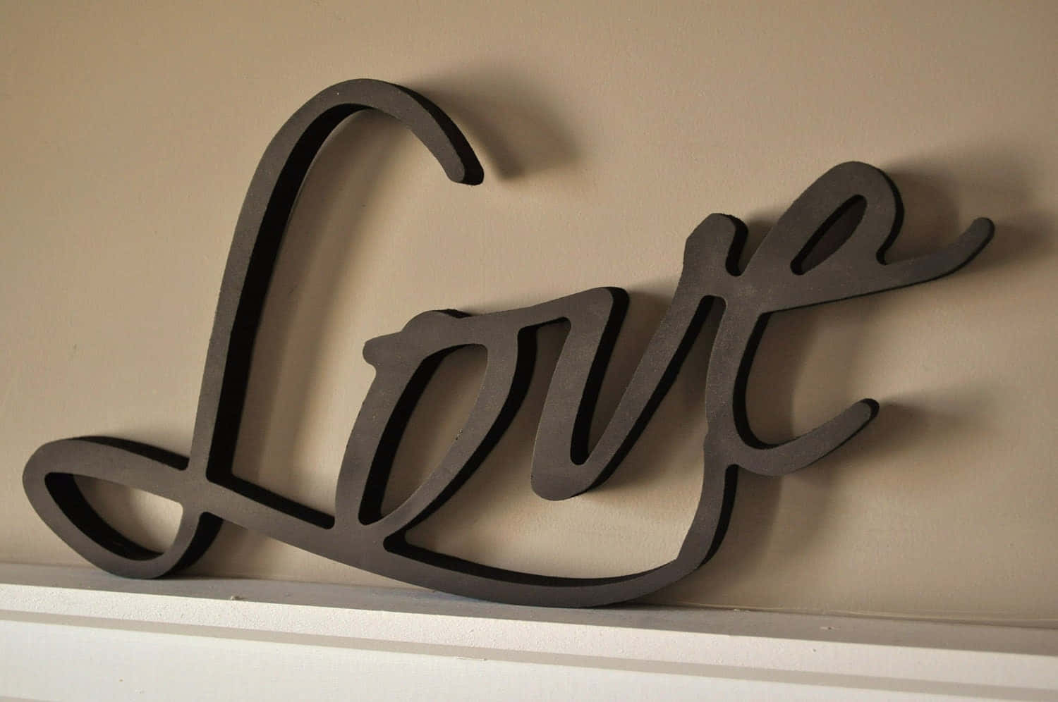 sleek black cursive 'Love' wall decor, beige wall, white shelf, HD Desktop Wallpaper