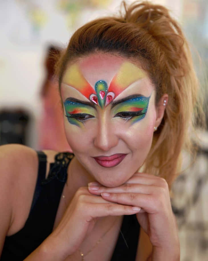 vibrant rainbow face paint, woman, smiles gently, SD Phone Wallpaper