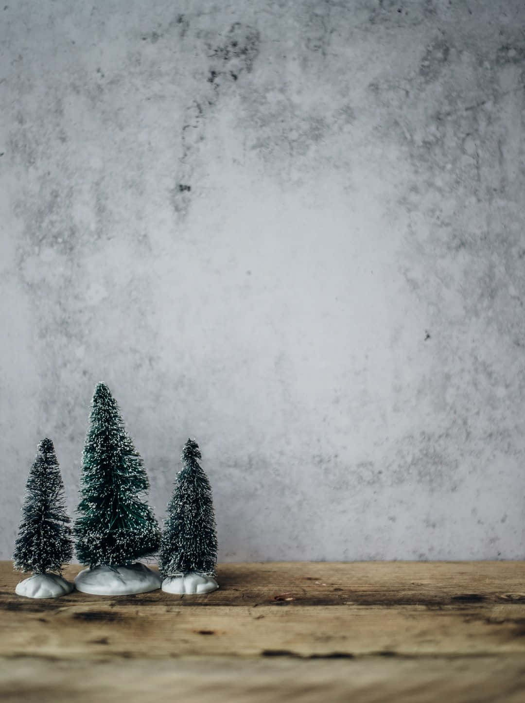 farmhouse christmas, miniature snow-dusted pine trees, rustic wooden surface, HD Phone Wallpaper