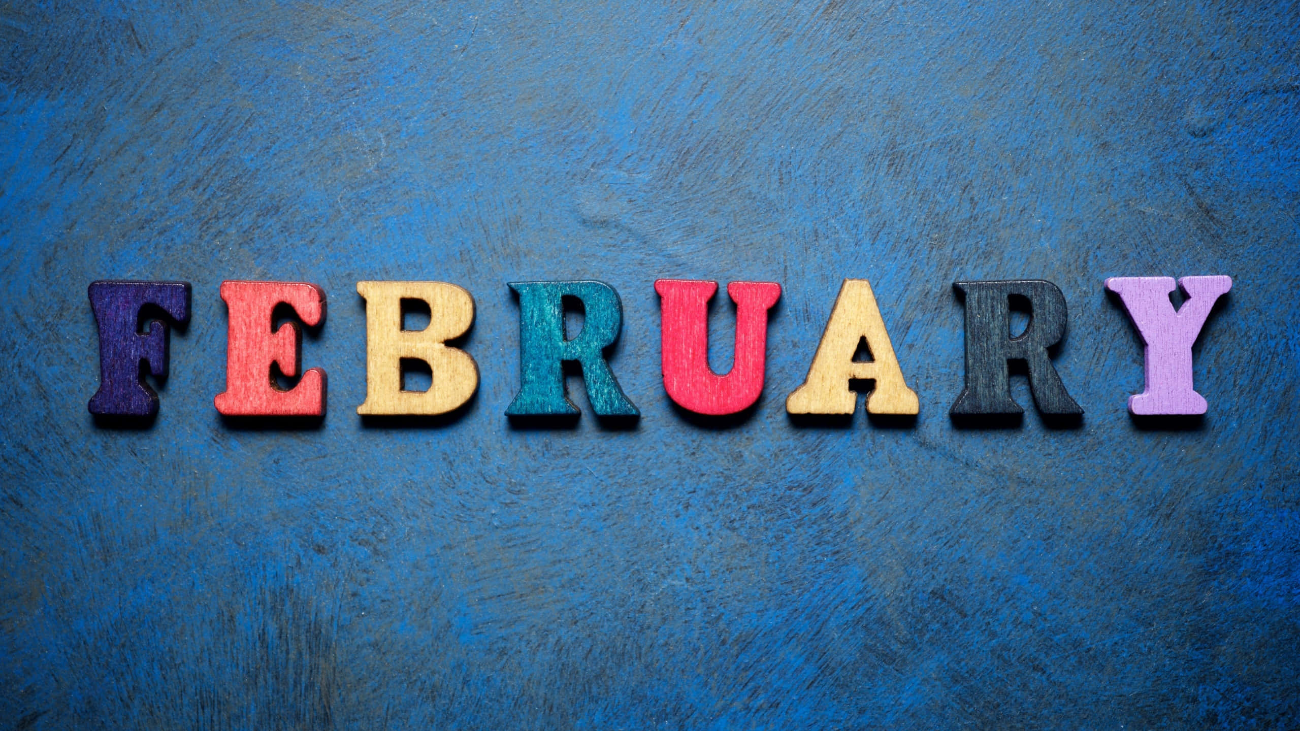 February, colorful wooden letters, textured blue background, 2K Desktop Wallpaper