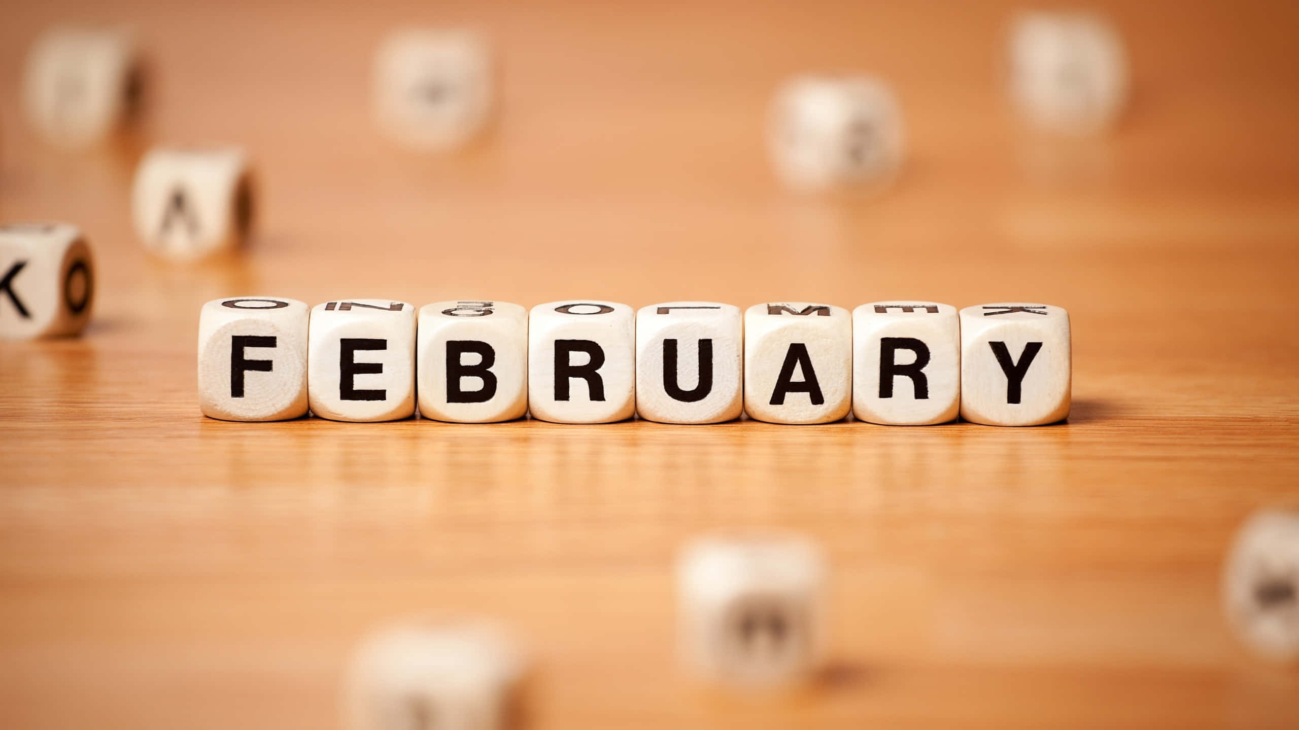 February, white letter cubes, warm wooden surface, 2K Desktop Wallpaper