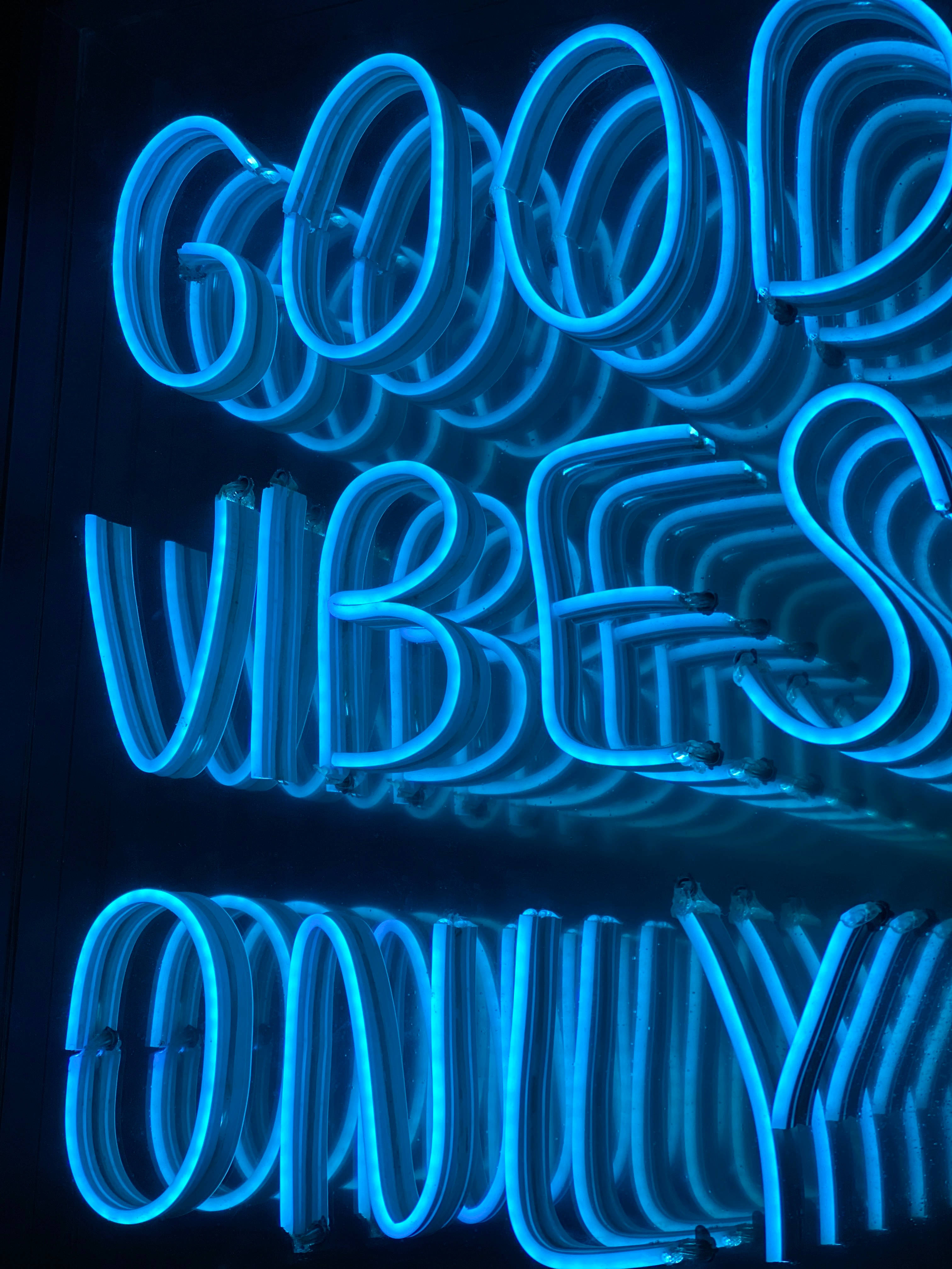 good vibes only, vibrant blue neon sign, dark reflective surface, 4K Phone Wallpaper