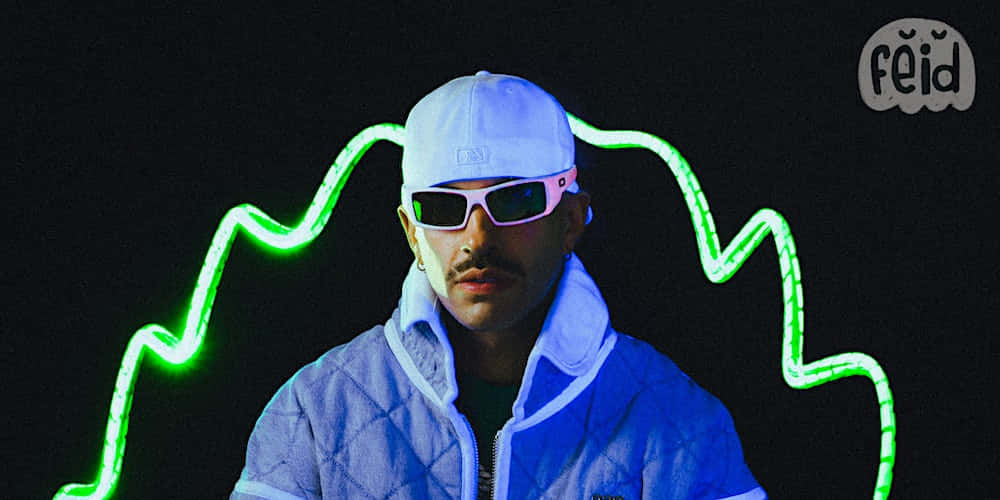 Feid, blue quilted jacket, white cap, SD Desktop Wallpaper