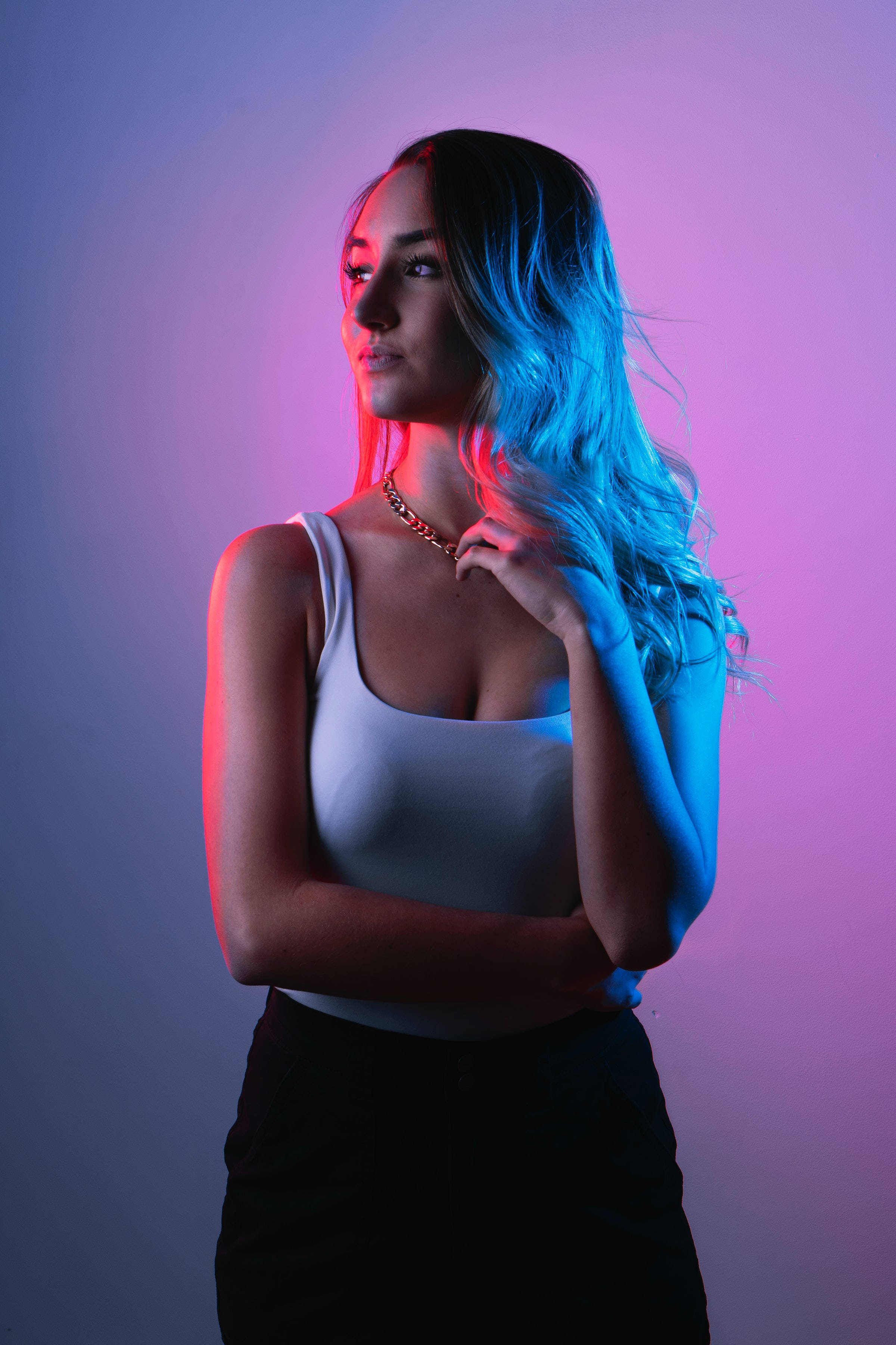 blue-tinted hair, gradient purple and blue background, neon red and blue lights, 2K Phone Wallpaper