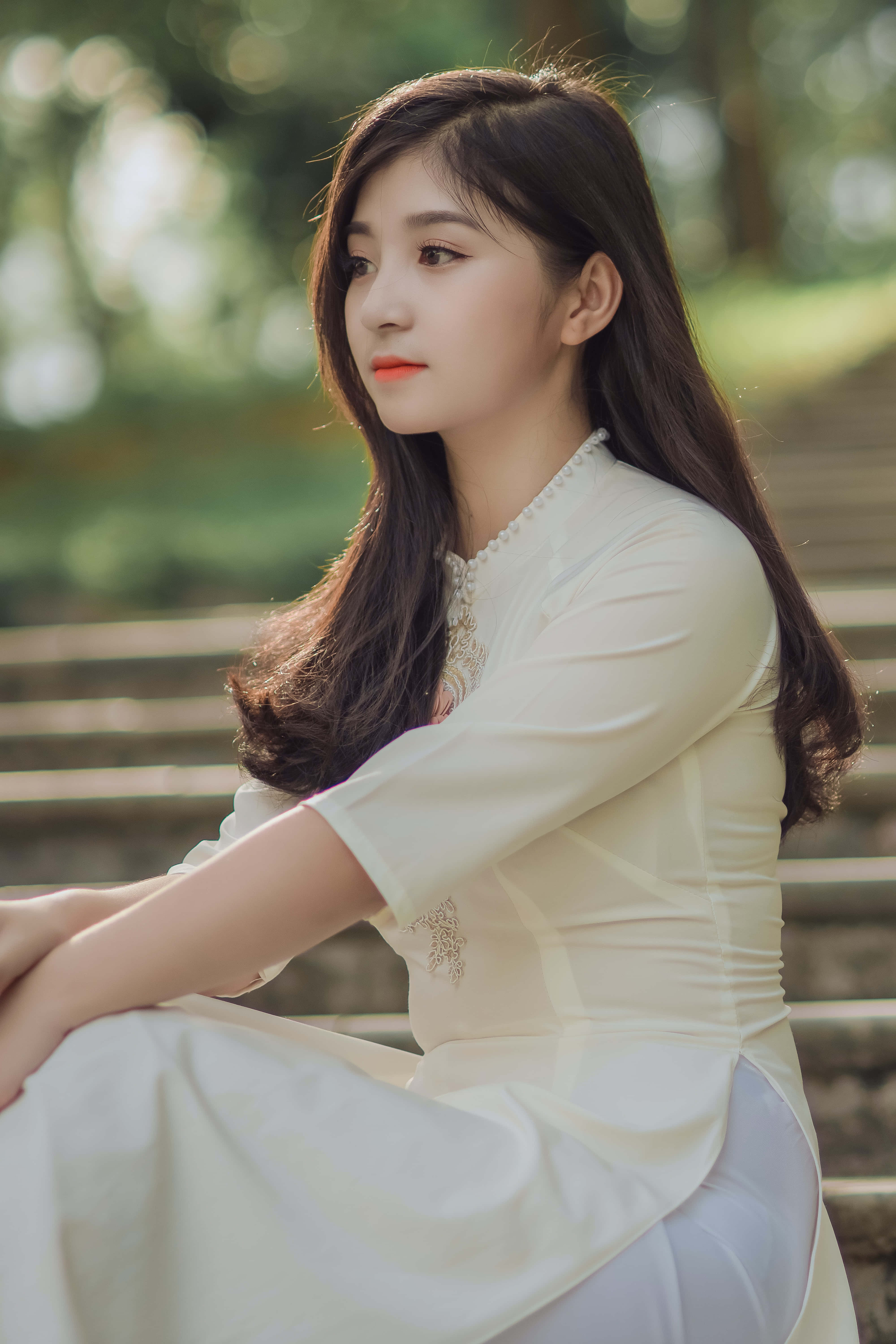 white traditional dress, stone steps, soft sunlight, 5K Phone Wallpaper