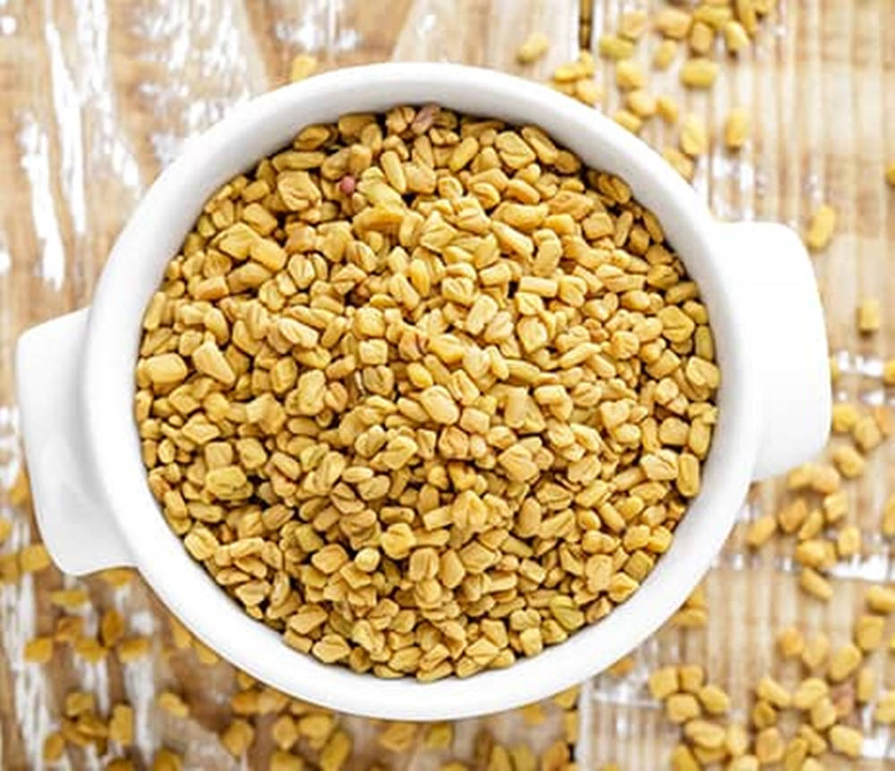 white ceramic bowl, golden fenugreek seeds, rustic wooden surface, SD Desktop Wallpaper