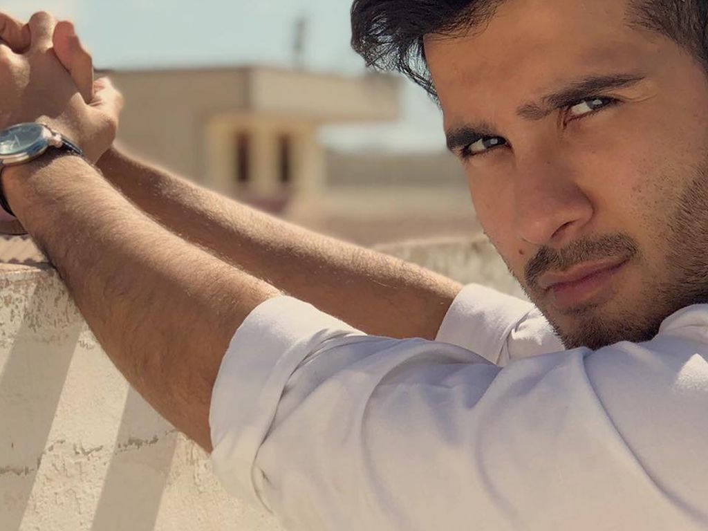 Feroz Khan, white shirt, sunlit stone wall, SD Desktop Wallpaper