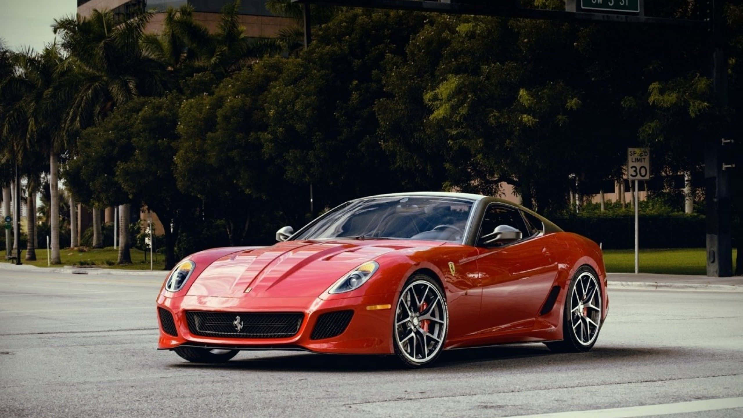 Ferrari 599 GTB Fiorano, vibrant red, tree-lined urban street, 2K Desktop Wallpaper