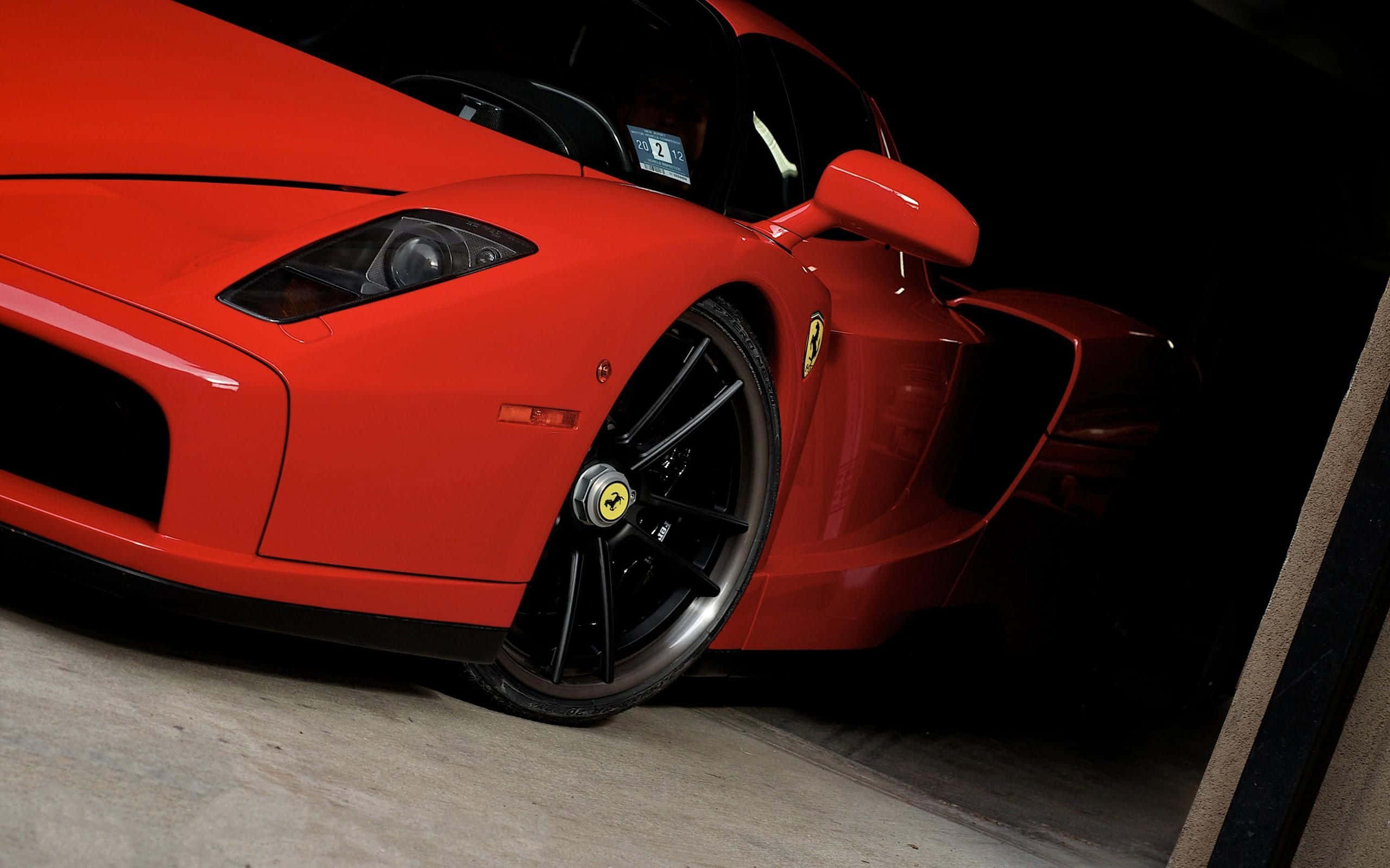 Ferrari Enzo, vibrant red, dimly lit garage, 2K Desktop Wallpaper