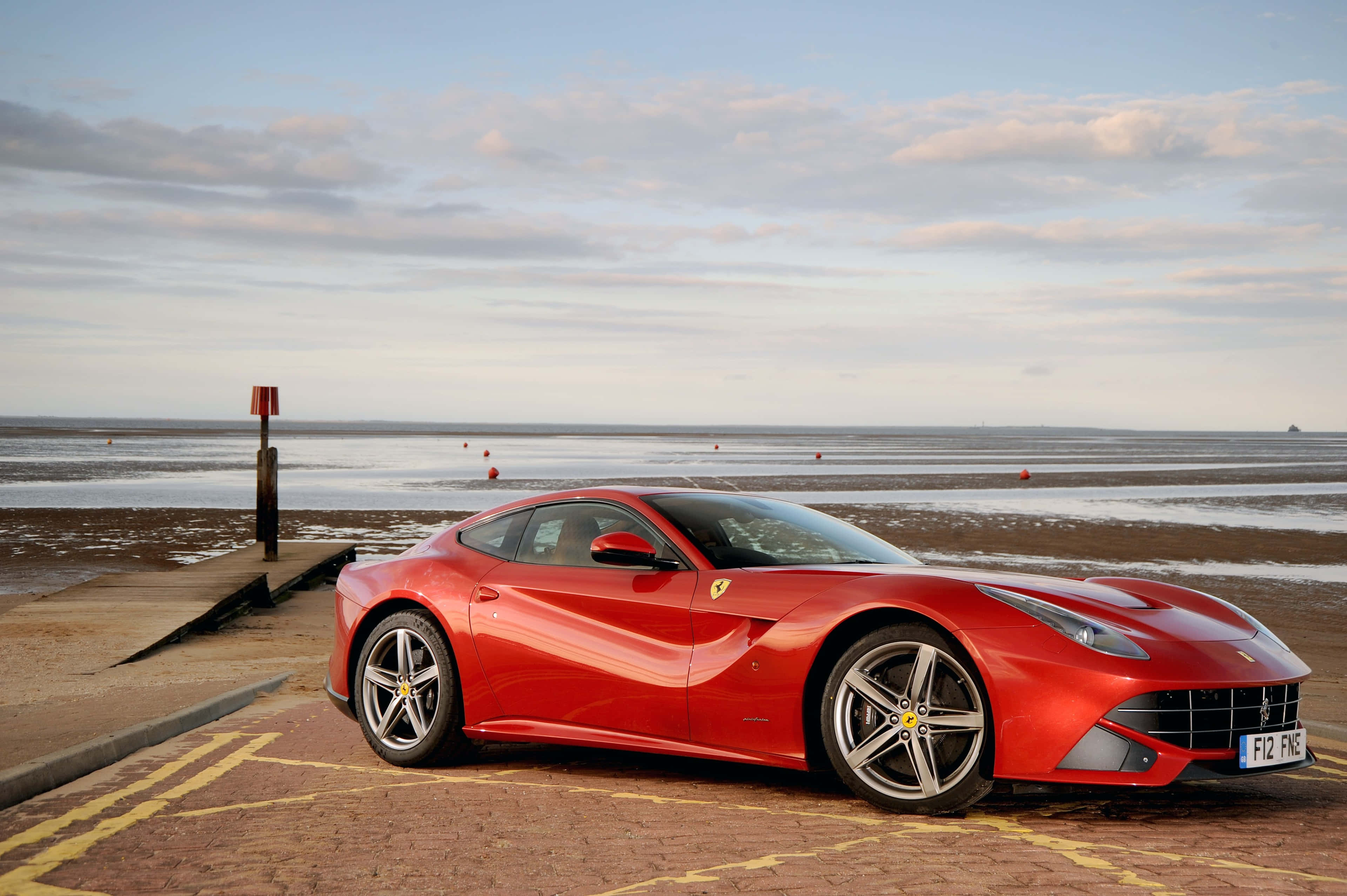 Ferrari F12 Berlinetta, glossy red, brick pier, 4K Desktop Wallpaper