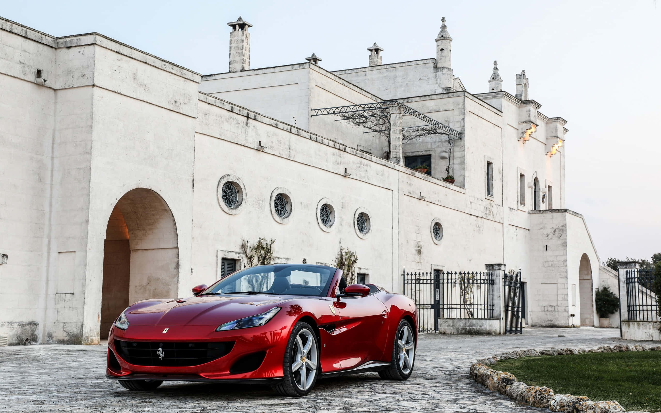 Ferrari Portofino, glossy red, cobblestones, 2K Desktop Wallpaper