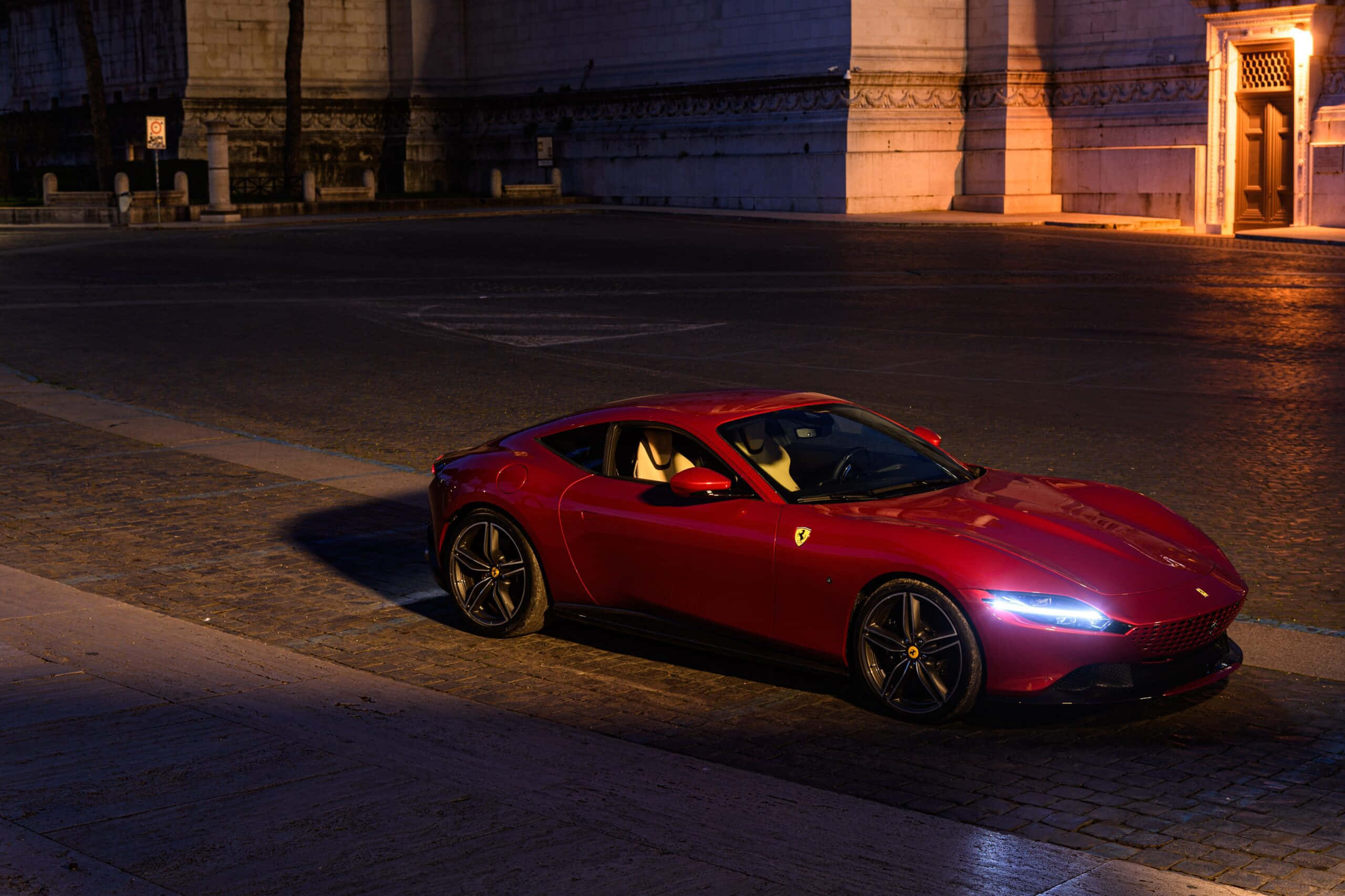 Ferrari Roma, glossy red, warm streetlights, 2K Desktop Wallpaper